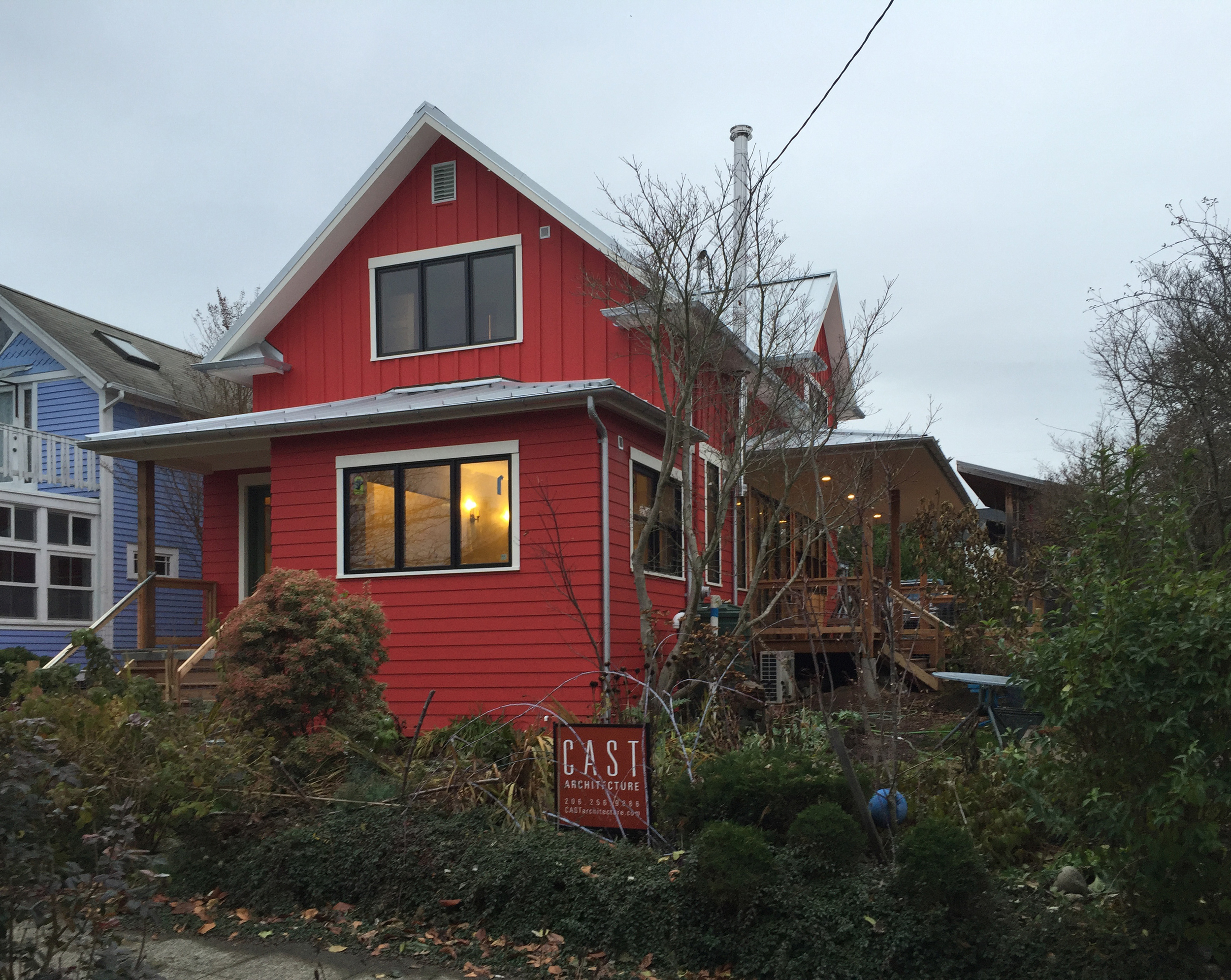 A glimpse of the covered veranda off of the kitchen and dining room is visible from the south facing street front. 