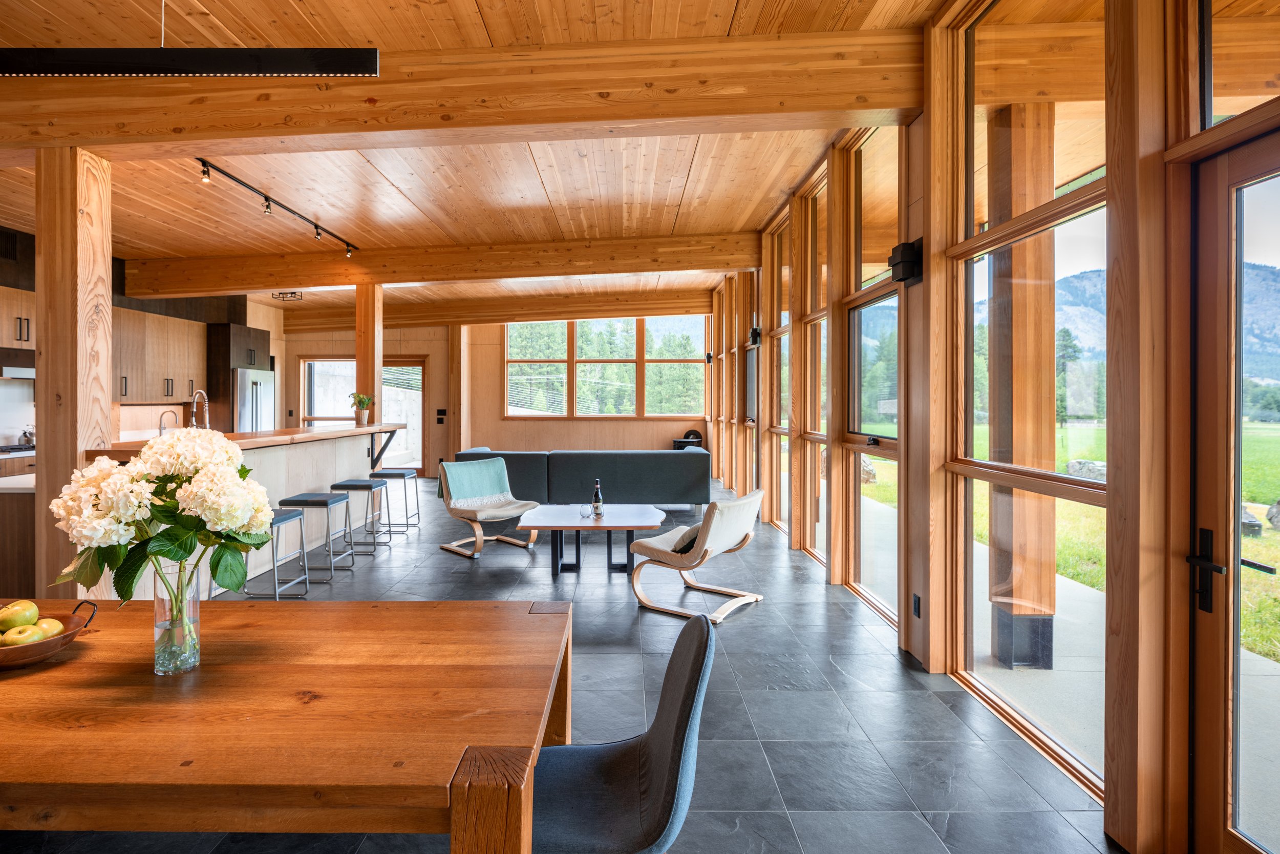  The Berm House is designed with Passive House principles, using superinsulation, advanced air sealing, cross-laminated timber panels, and a live roof. And, it serves as a common house for its co-housing neighborhood, reflecting a vision of community