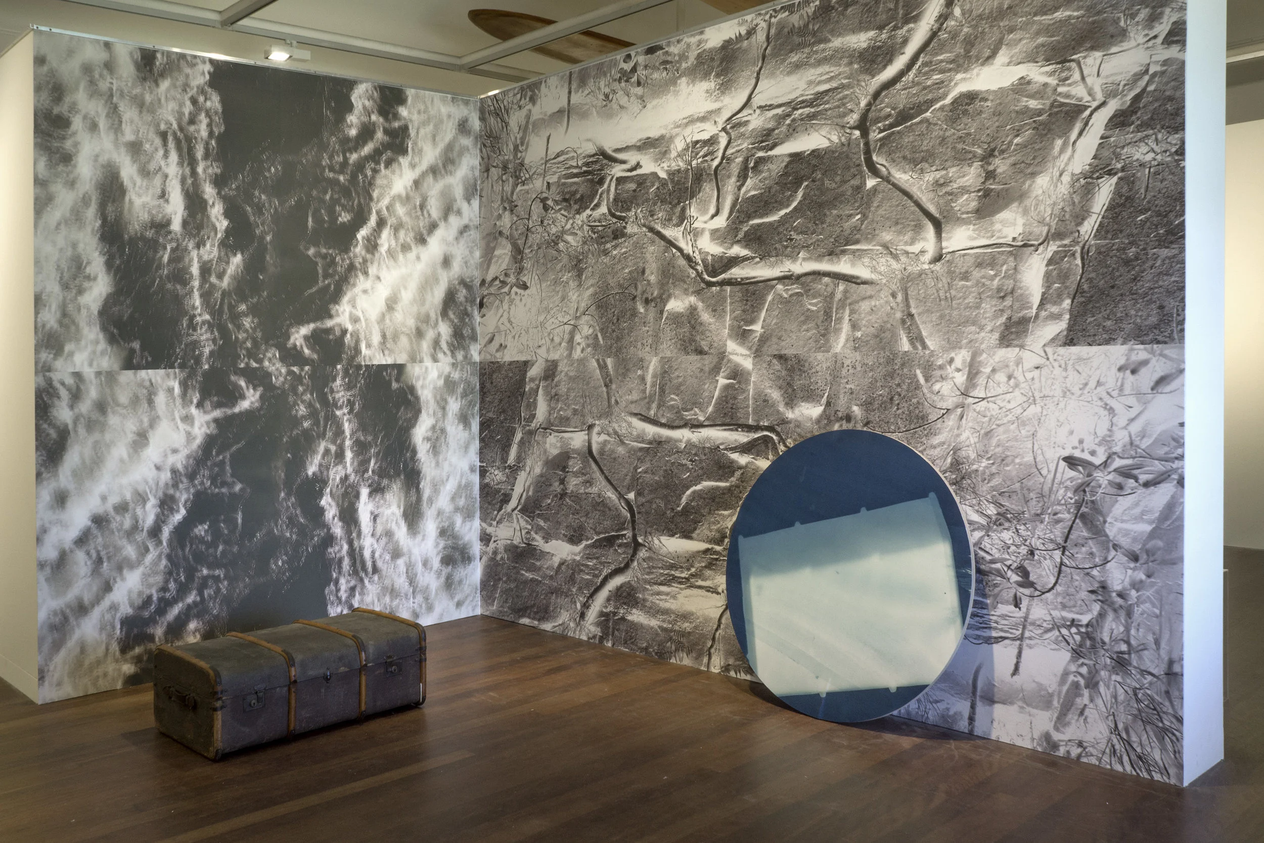 Motionless vessel 2015, vinyl wallpaper 282 x 360 cm; Vessel in flux 2015, vinyl wallpaper, 282 x 232 cm; Suitcase 2015, cyanotype print on plywood, 1100mm diameter. installation view, Manley Art Gallery and Museum
