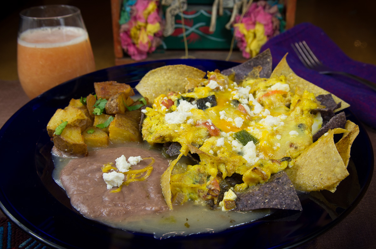 Migas, green sauce with glass of orange juice