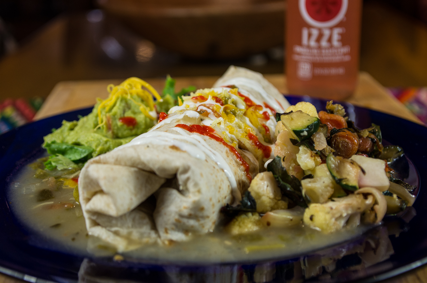 Burrito, green sauce with side of roasted vegetables