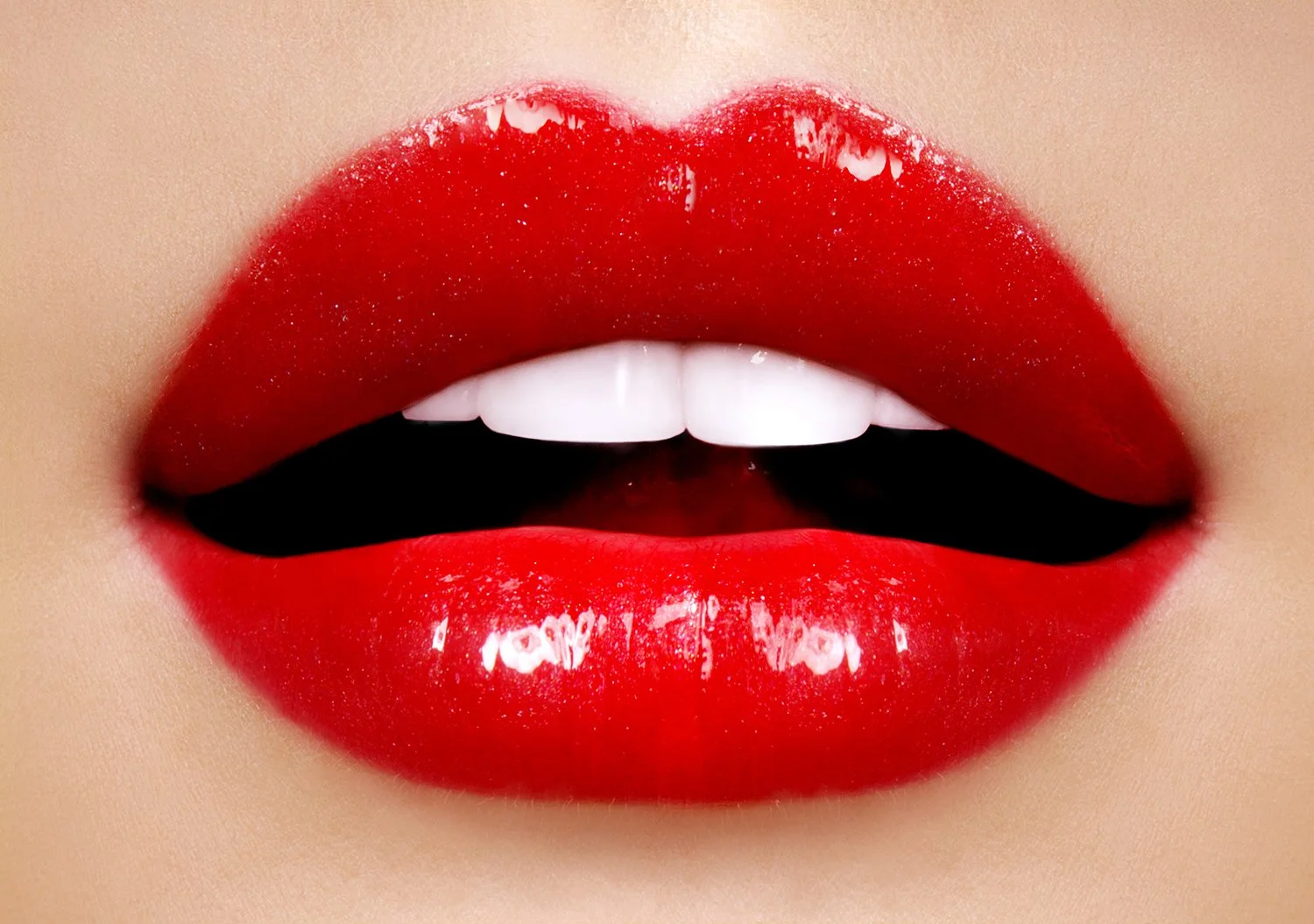 Extreme macro beauty photography by L.A. and Munich based expert Daniella Hehmann, highlighting ultra-high-gloss red lips with a reflective mirror finish and perfectly textured dewy skin under professional studio light.