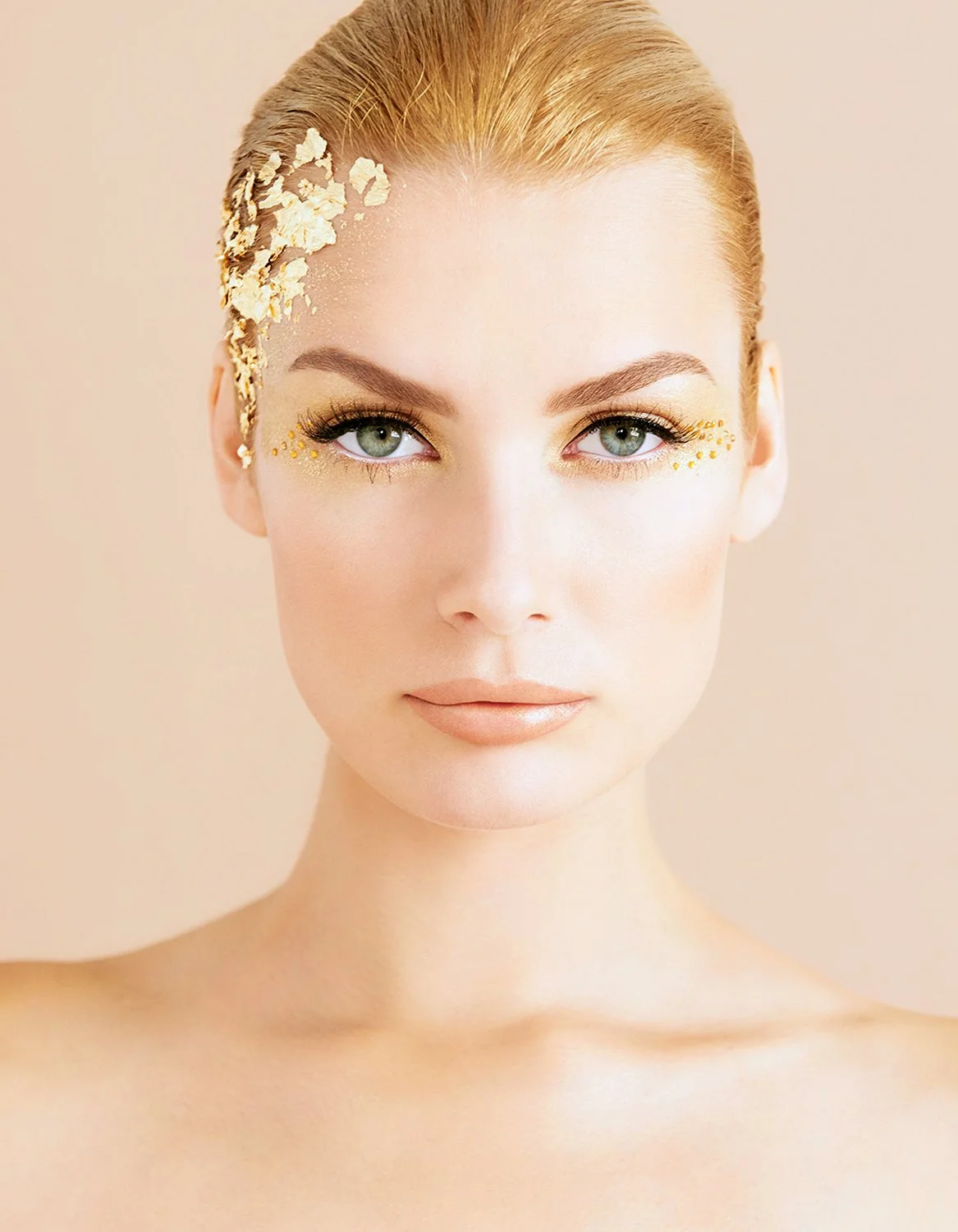 Beauty advertising shot for Senna Cosmetics featuring makeup by Eugenia Weston and photography by Daniella Hehmann. This "Golden Eye" inspired look is captured with bright, even commercial lighting that enhances the golden shimmer on the eyelids and 