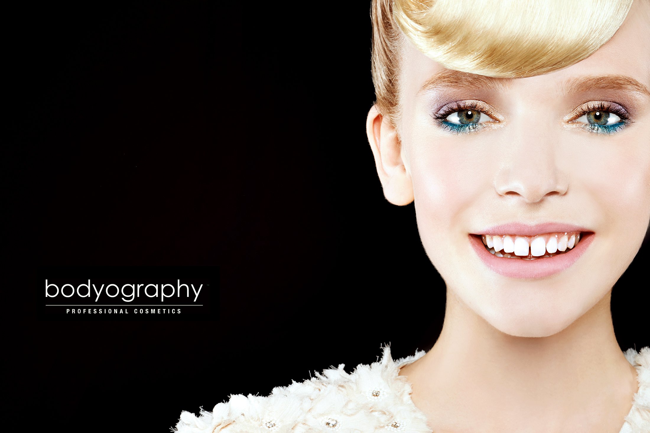 Commercial cosmetic shot for Bodyography by expert photographer Daniella Hehmann. Featuring a bold, high-pigment makeup look, the skin is rendered with a fresh, hydrated glow using focused rim lighting on a black studio background. Leading beauty pho