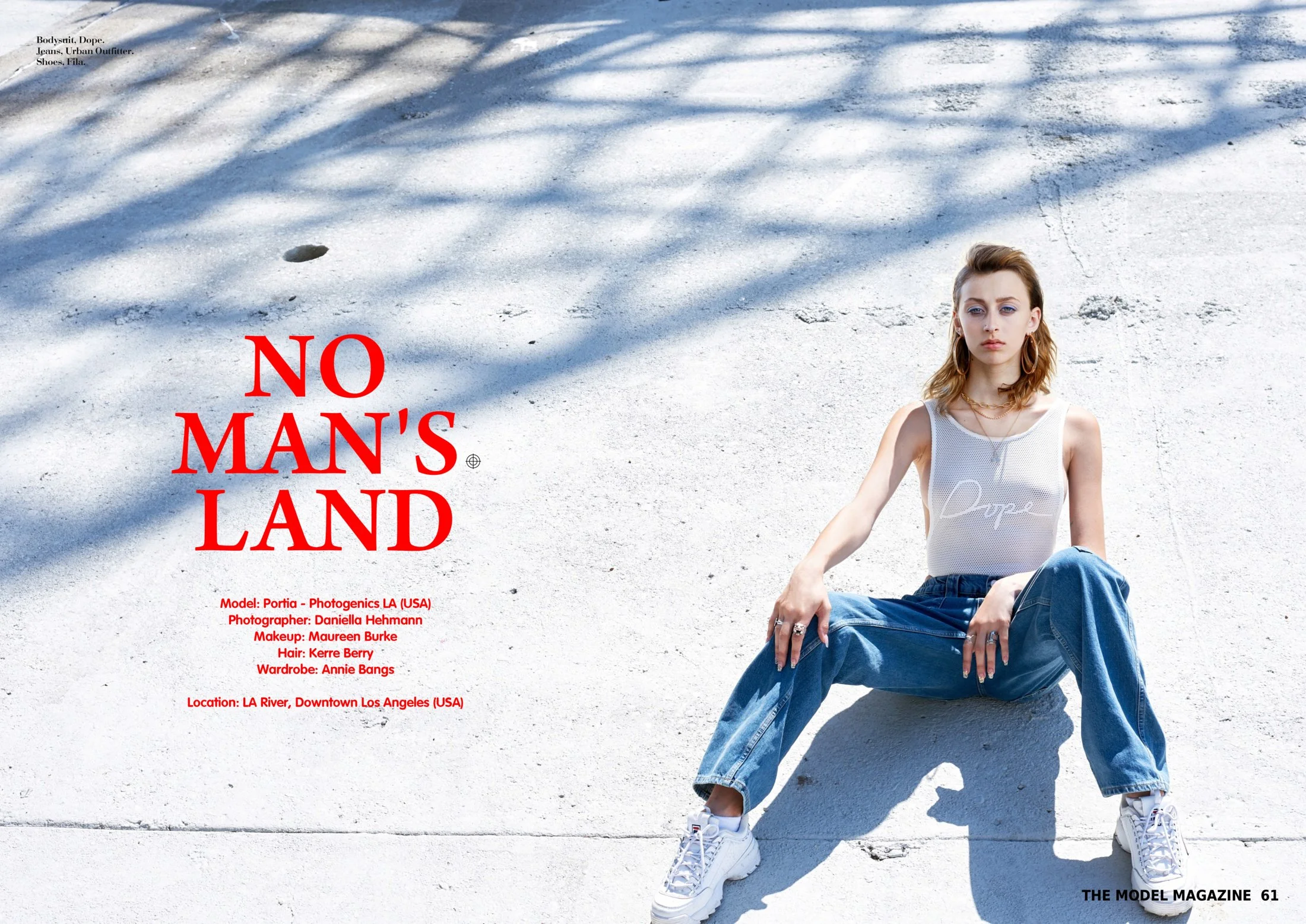 A young woman with wavy hair and large hoop earrings sitting on a white concrete surface with shadows cast above. The left side of the image has red text that reads 'NO MAN'S LAND,' with additional smaller text providing model, photographer, makeup a