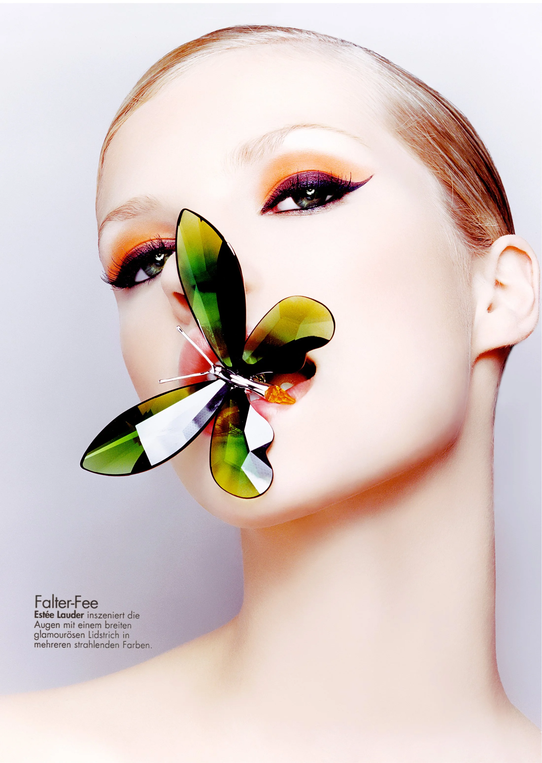 A woman with makeup and the eyeshadow in shades of orange and purple. She has a large butterfly on her face with green, black, and white wings.