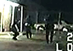 This is a close up of the previous image. Note that Officer Hathorn on the left is again crouching/ducking down, apparently believing the suspect is about to turn around once more.