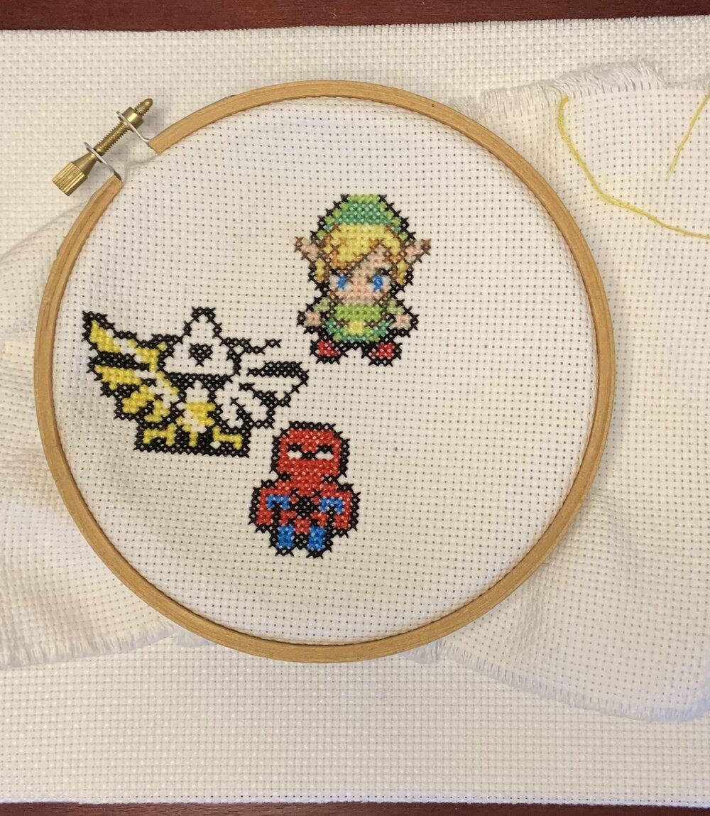 Cross stitch of various video game characters and symbols