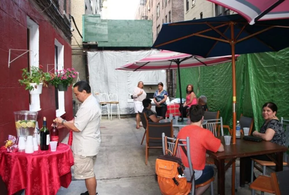 Members of a New York co-op celebrate the end of a series of training workshops with a backyard barbecue. Care of UHAB