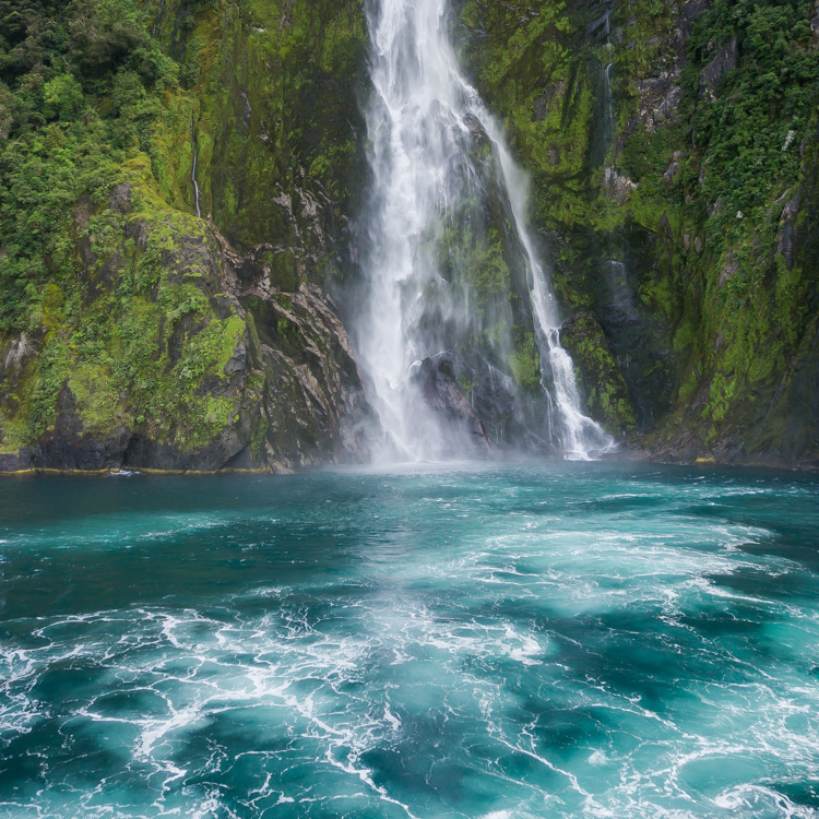 Waterfall in milford sound, new zealand