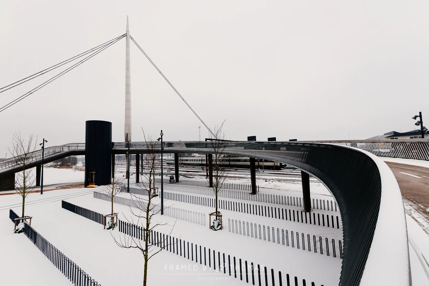 Bicycle parking in snow at Byens bro (bridge) in Odense, Denmark