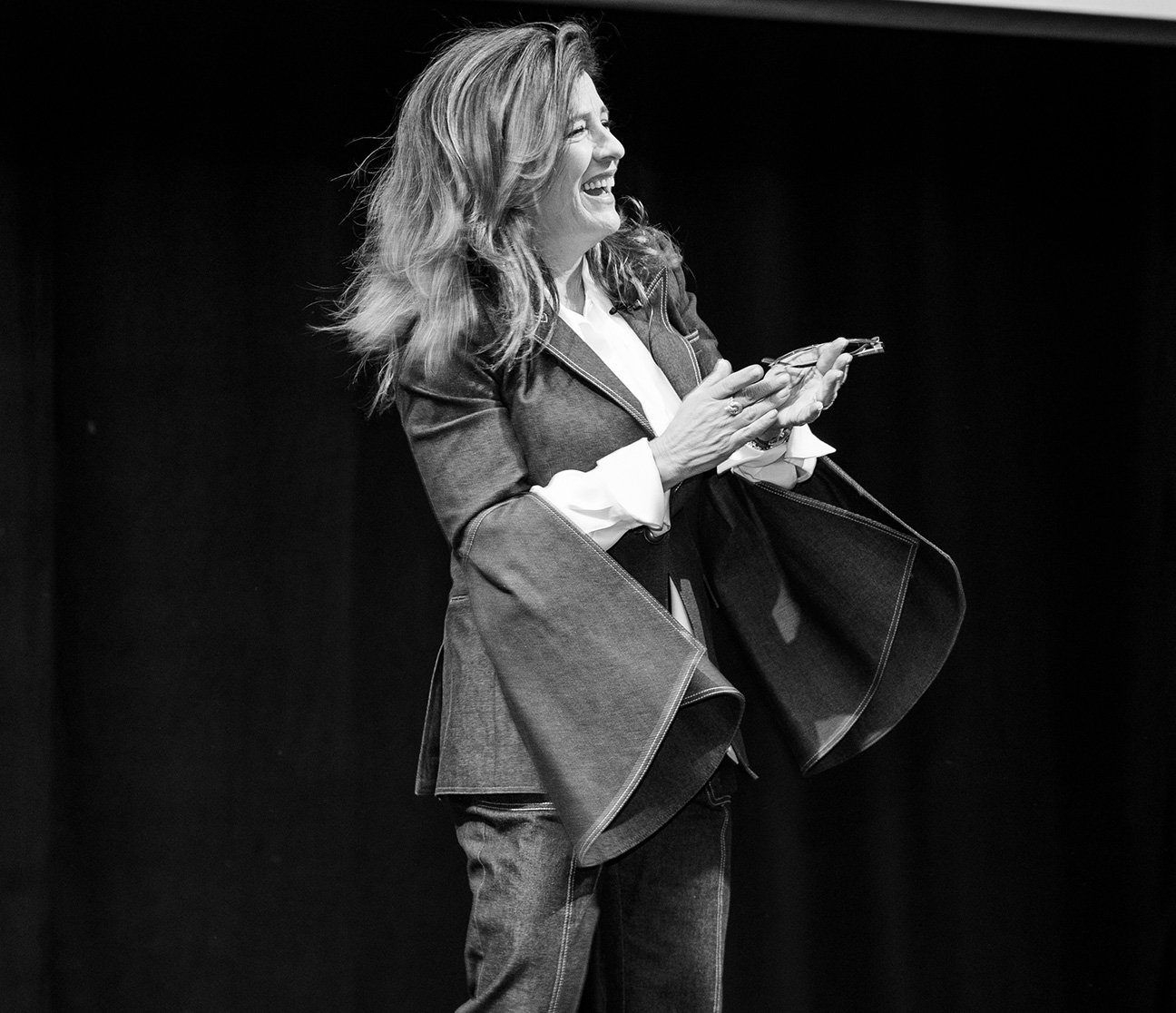 Wendy Burk, CEO of Cadence Travel, is pictured giving a speech.