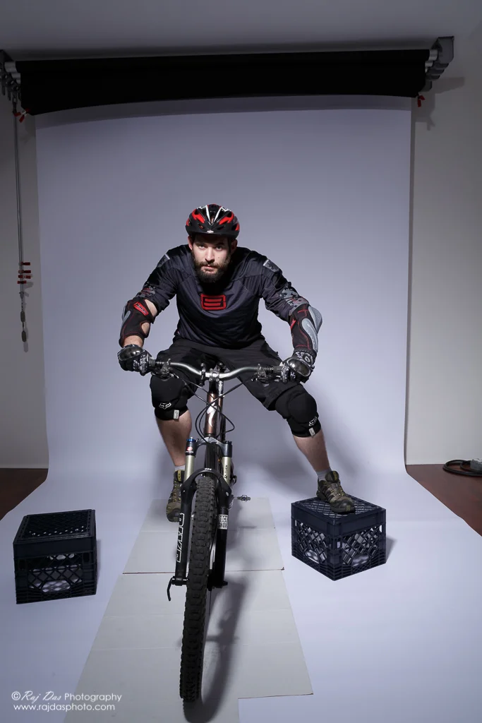 Jason on his bike in the studio with right foot on pedal