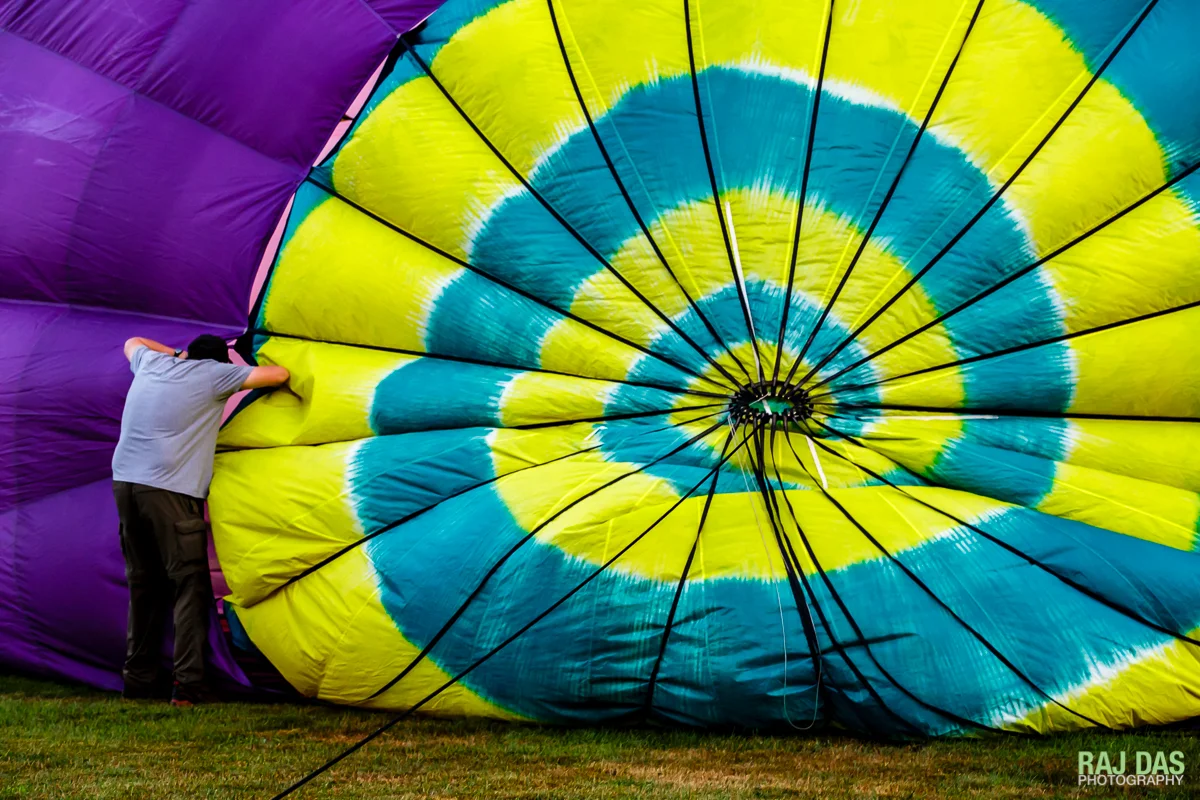 As the balloon is inflated, a crew member peers in through the vents near the crown