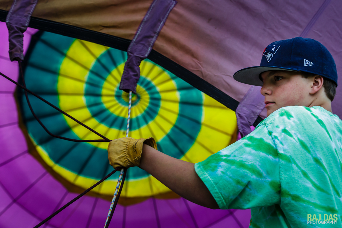 A crew member holds on to the lines as the balloon is inflated