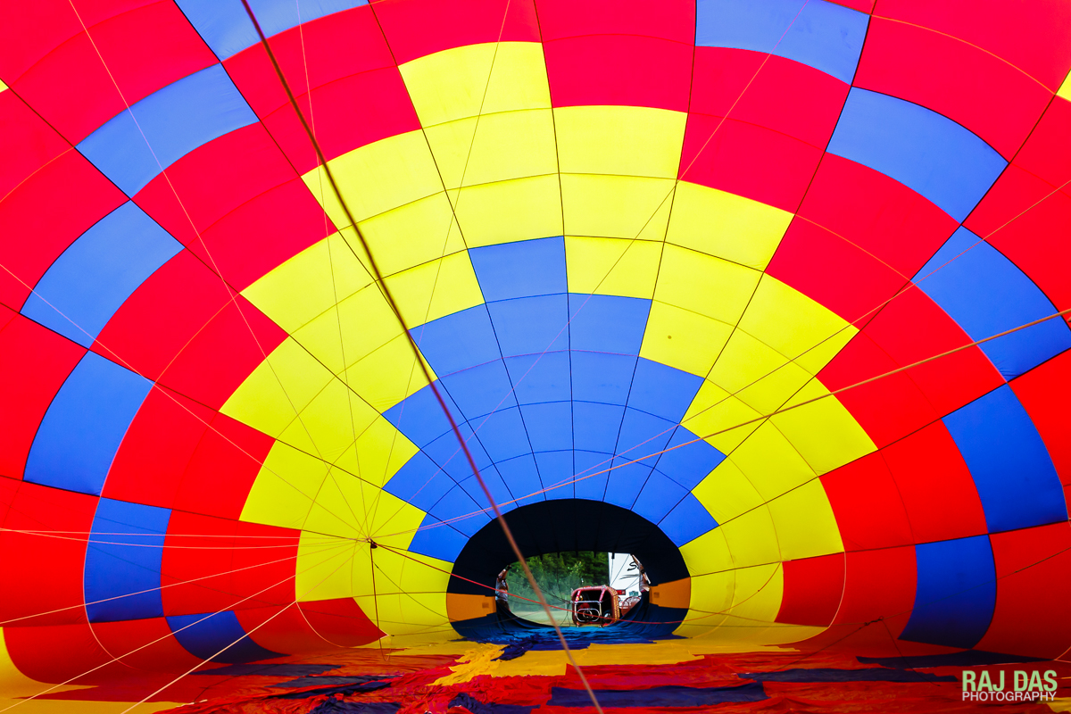 View through the vents near the crown of another balloon as it is being inflated