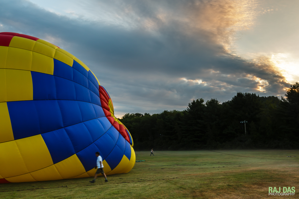 Pilots and crew check on the crown lines as the balloons get inflated