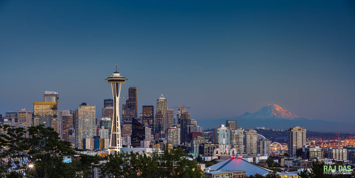 Dusk settles over Seattle as the last rays of the setting sun kiss the peak of Mt. Rainier