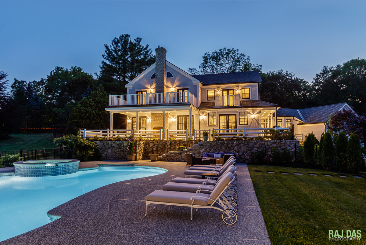 Pool side view of the residence at dusk