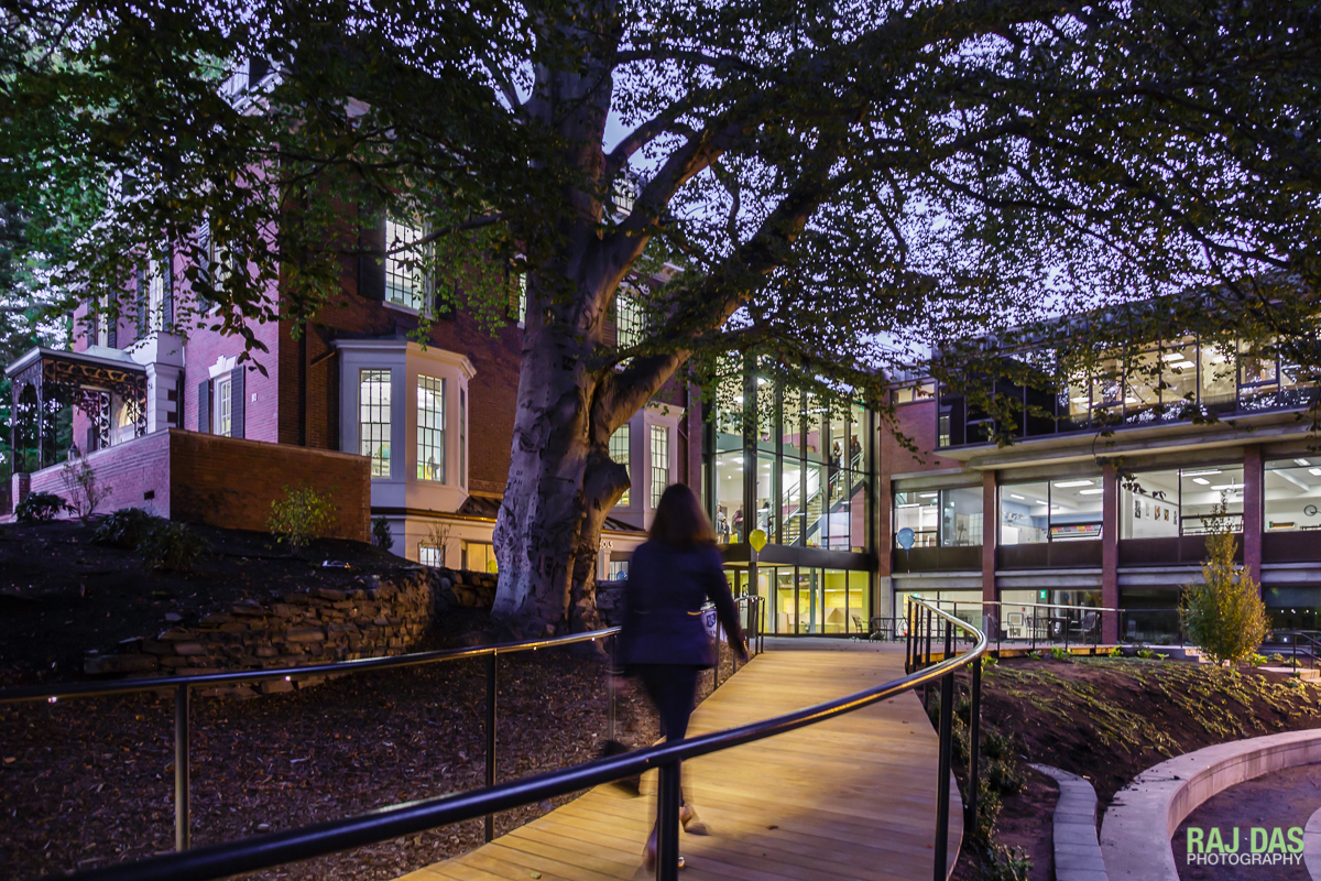 The boardwalk lit by the lights underneath the railings lead up to the entrance and foyer
