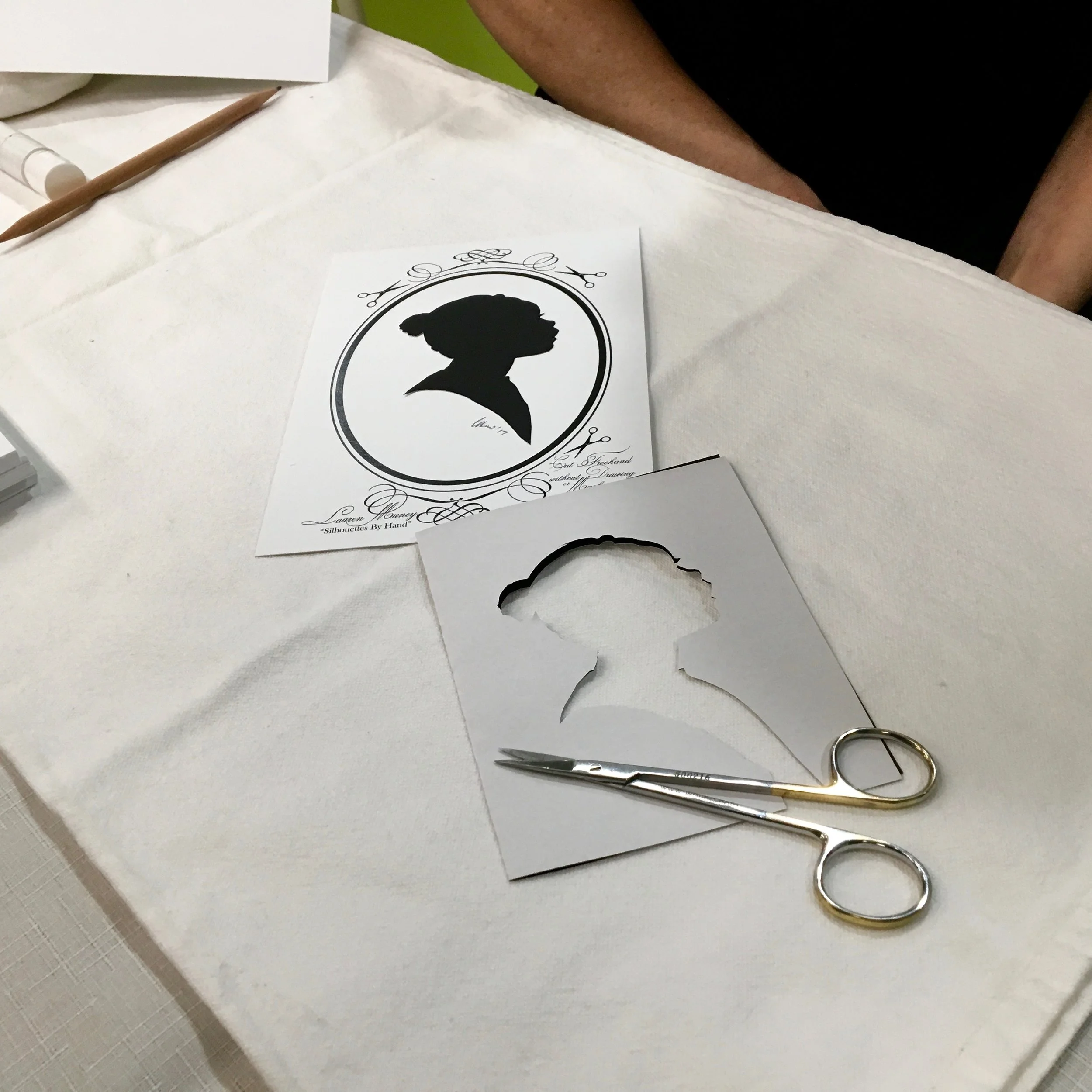 Traditional Silhouette portraits are cut freehand with only scissors, without any device or even a shadow. Experience this rare and old portrait form for yourself. (Photo by Tony Ventouris for Montgomery Parks, USA. More photos are here. )