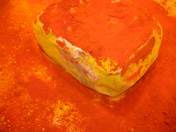 Detail of turmeric n red chili powder on the ceramic boulder 