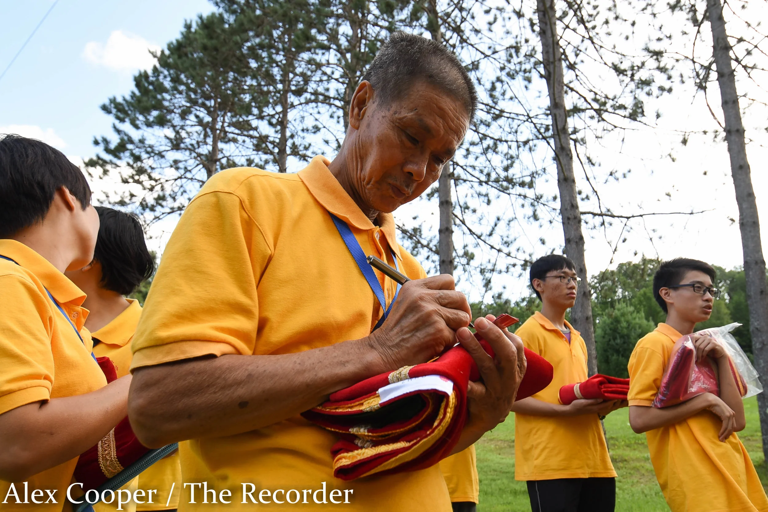 Alex Cooper / Recorder staff Zan Ming Chen writes a note on a donation before the start of a soul relieving ceremony on Wednesday, August 17, at the Ephratah Villa. The ceremony is known as the Hungry Ghost Festival. In Chinese culture, the fifteent…