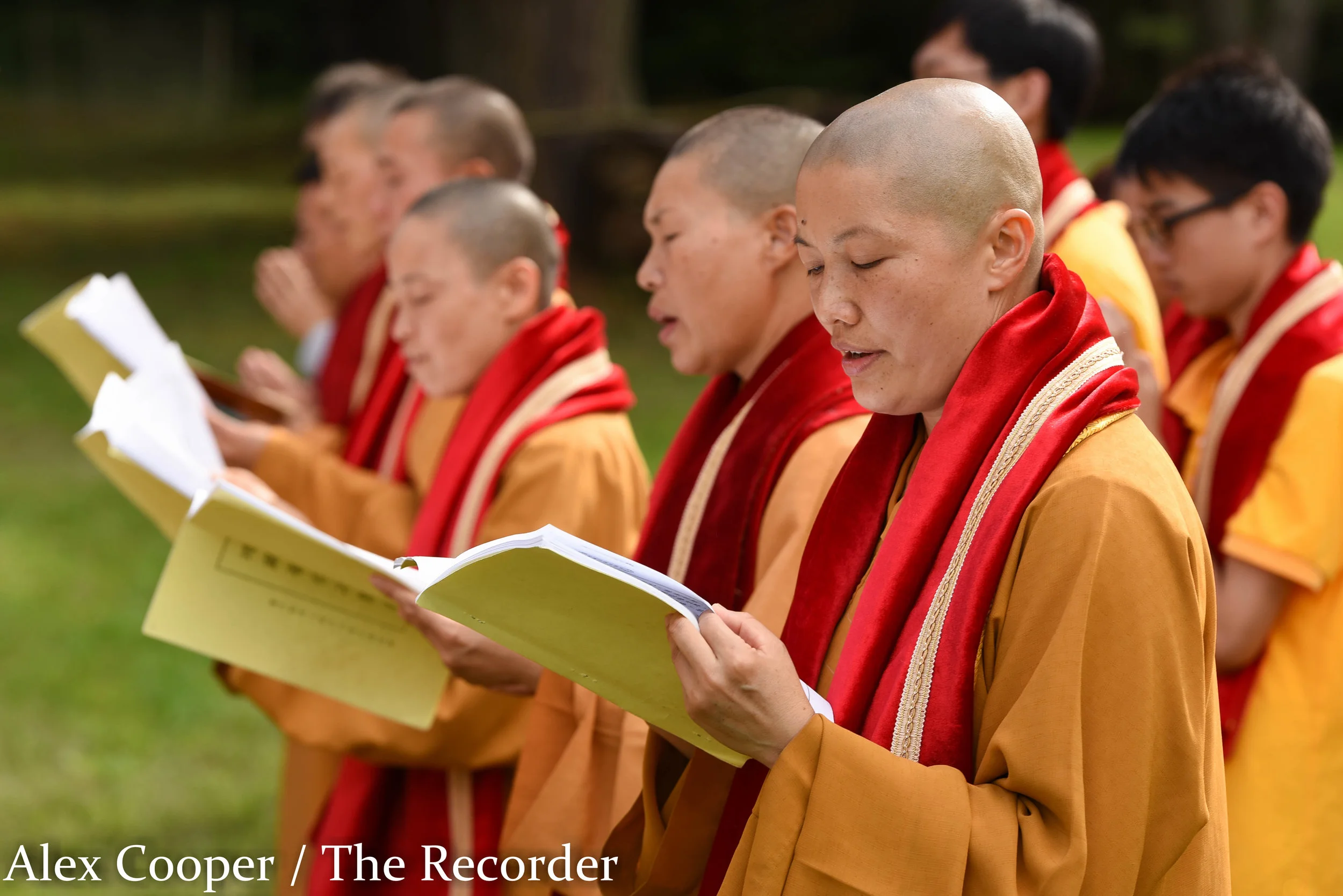 Alex Cooper / Recorder staff Preacher Miao Si, far right, reads from the sutra with others during a Hungry Ghost Festival on Wednesday, August 17, at the Ephratah Villa. In Buddhism, the sutra refers to the religious texts, many of which are regarde…