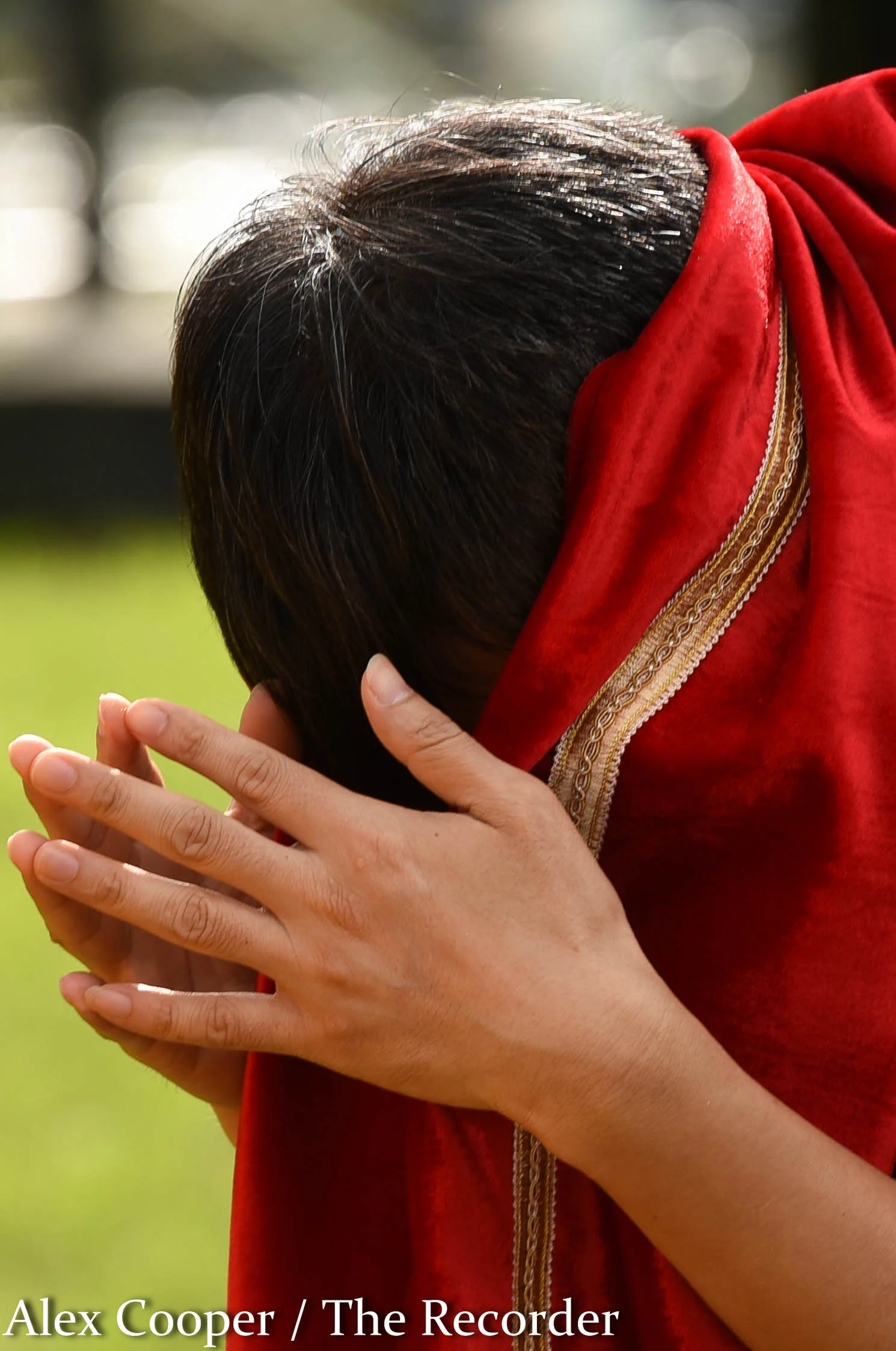 Alex Cooper / Recorder staff A young man covers his face while praying during the peak of a Hungry Ghost Festival on Wednesday, August 17, at the Ephratah Villa. During this point in the festival, many students and preachers were becoming emotional …
