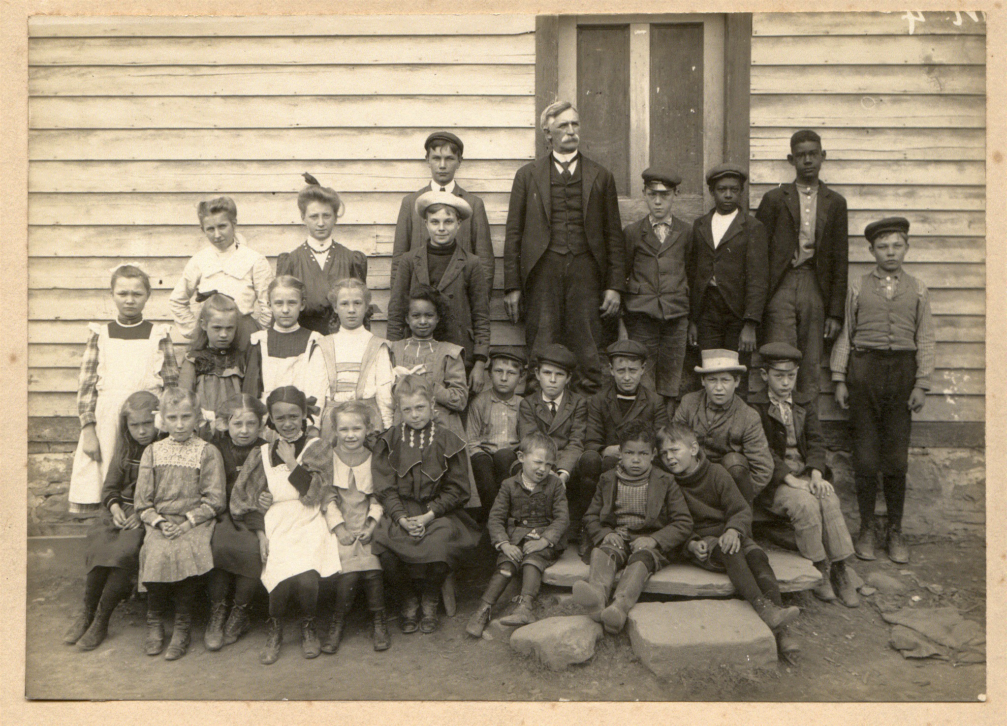This is a picture of my great grandfather's school in Lomontville, NY. He is the gentleman in the back with the mustachios. My grandmother is in the front row; 5th from the left.