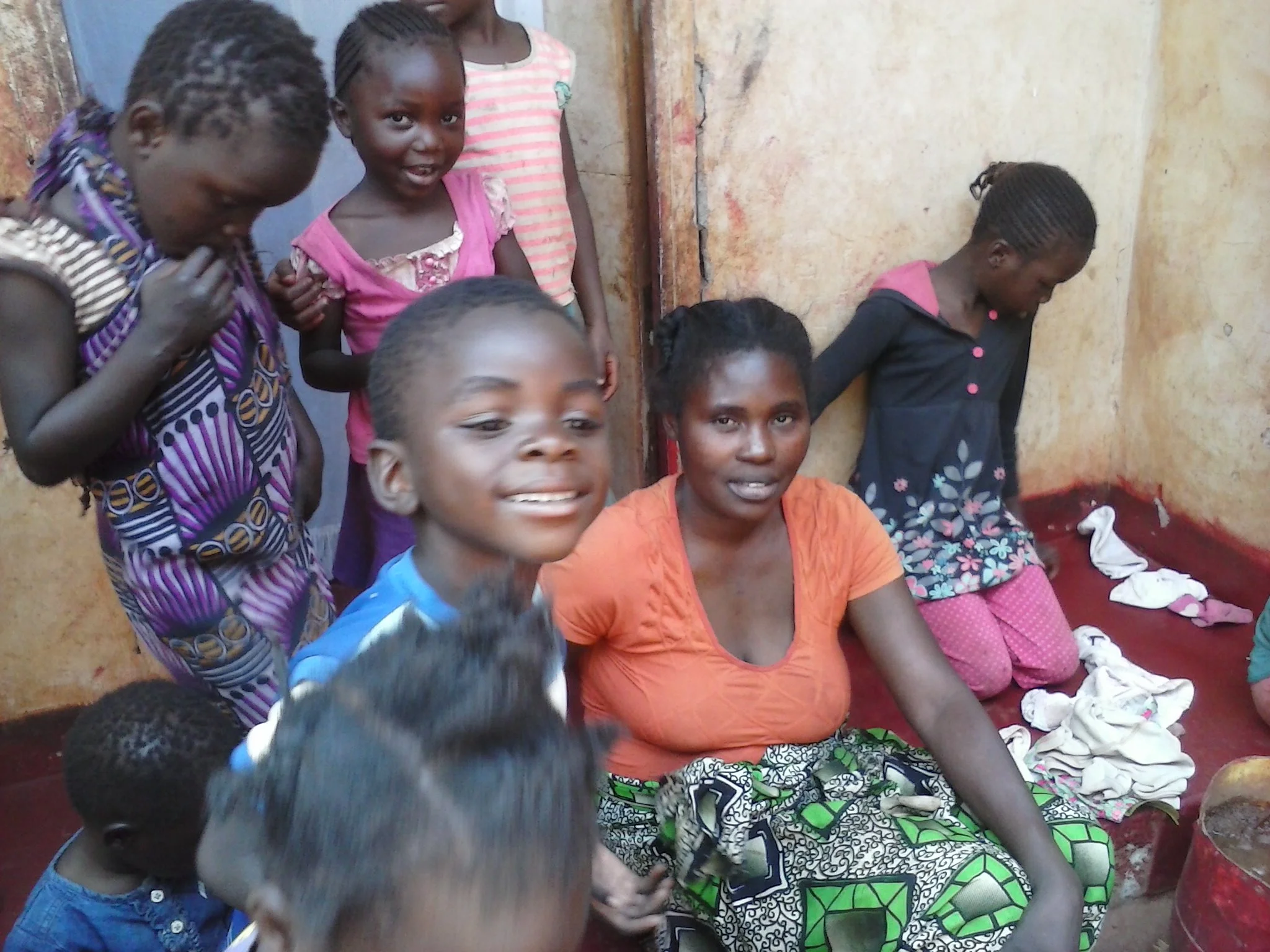 Mulenga visits a mother and her children at their home in Chainda compound during his August 2014 visit to Zambia