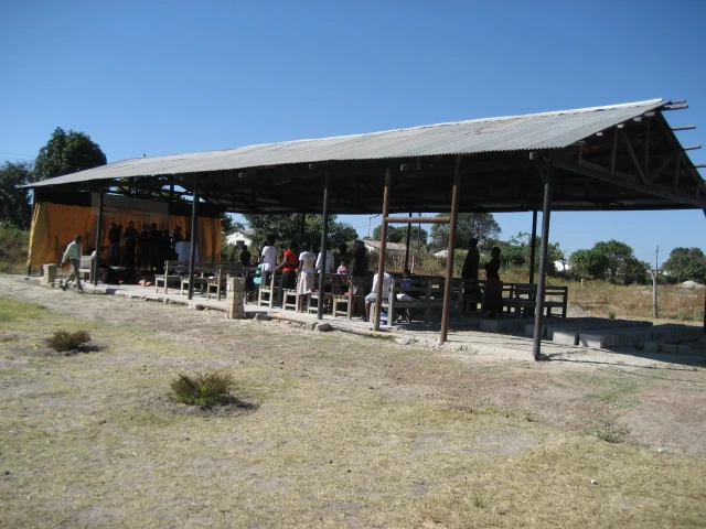 Mulenga pastoring a rural Zambian congregation from within a simple church structure in March 2010.
