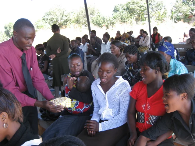 Sharing the elements of Holy Communion with church members.