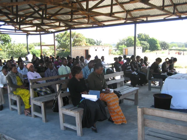 Church members in rural Zambia enjoy Mulenga preaching a Sunday sermon.