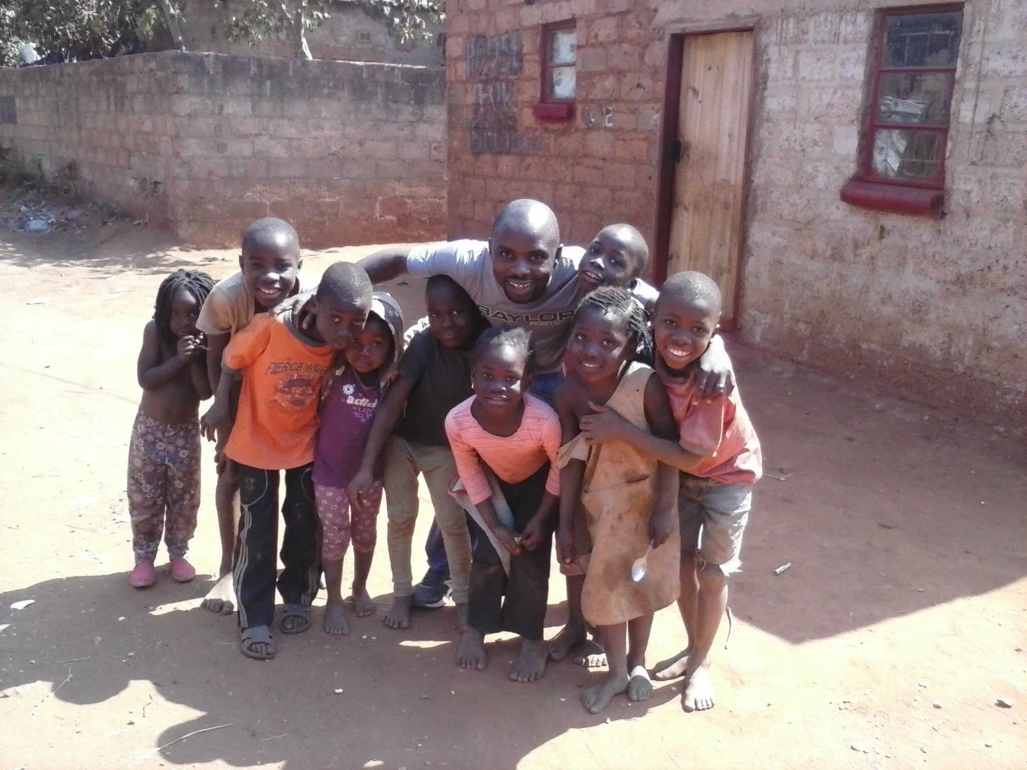 Mulenga and the children in Chainda compound share a big group hug, August 2014.