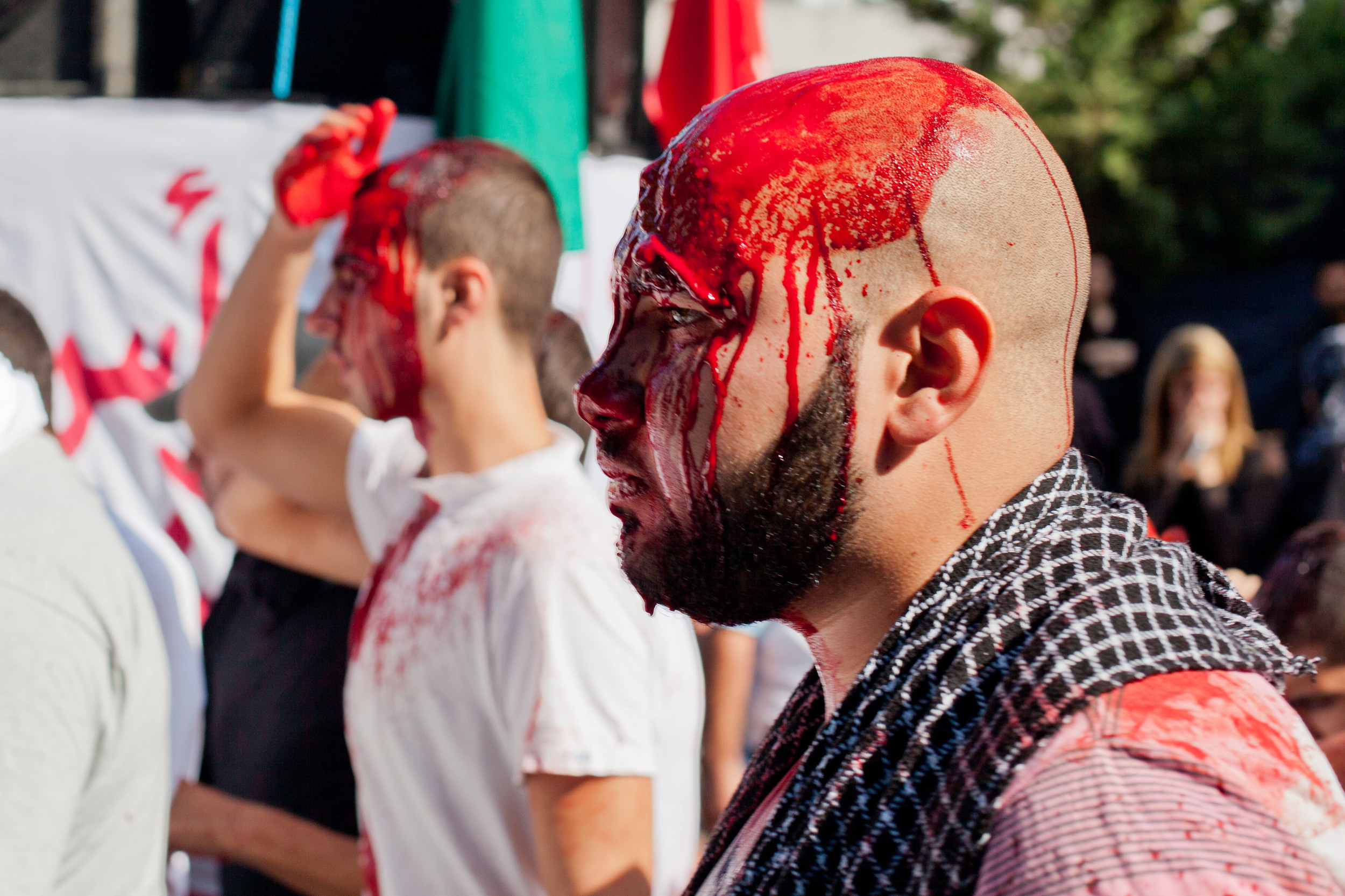 A blood-soaked man marches in this Ashura procession. (Courtesy James Haines-Young)