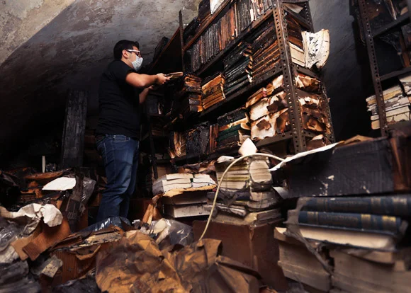 Charred books in Tripoli's Al-Saeh library. (Courtesy Hussein Malla/AP) 