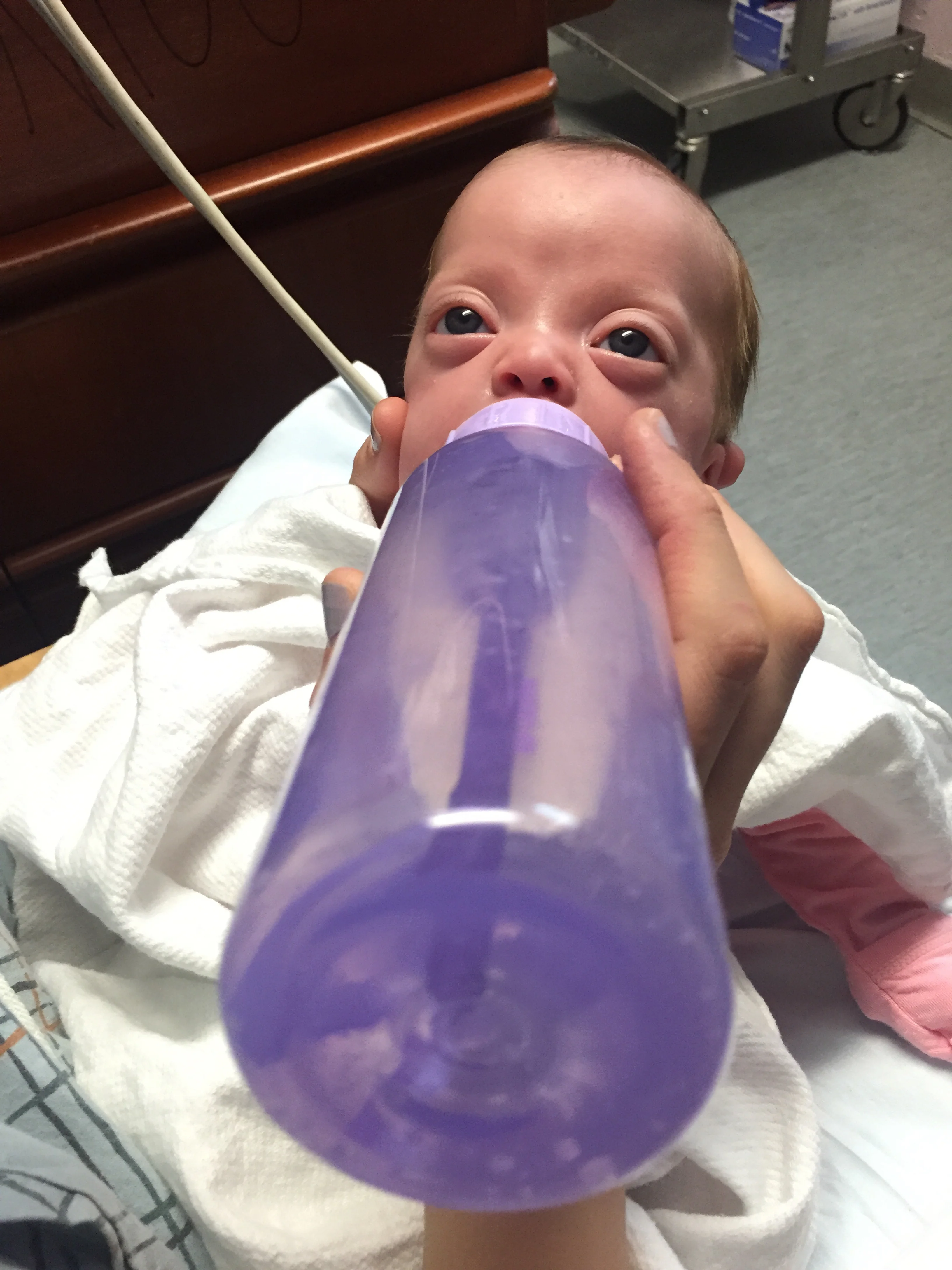 Getting used to her new bottle that she'll be using at home. (That's right, Dr. Brown's bottles come in purple!)
