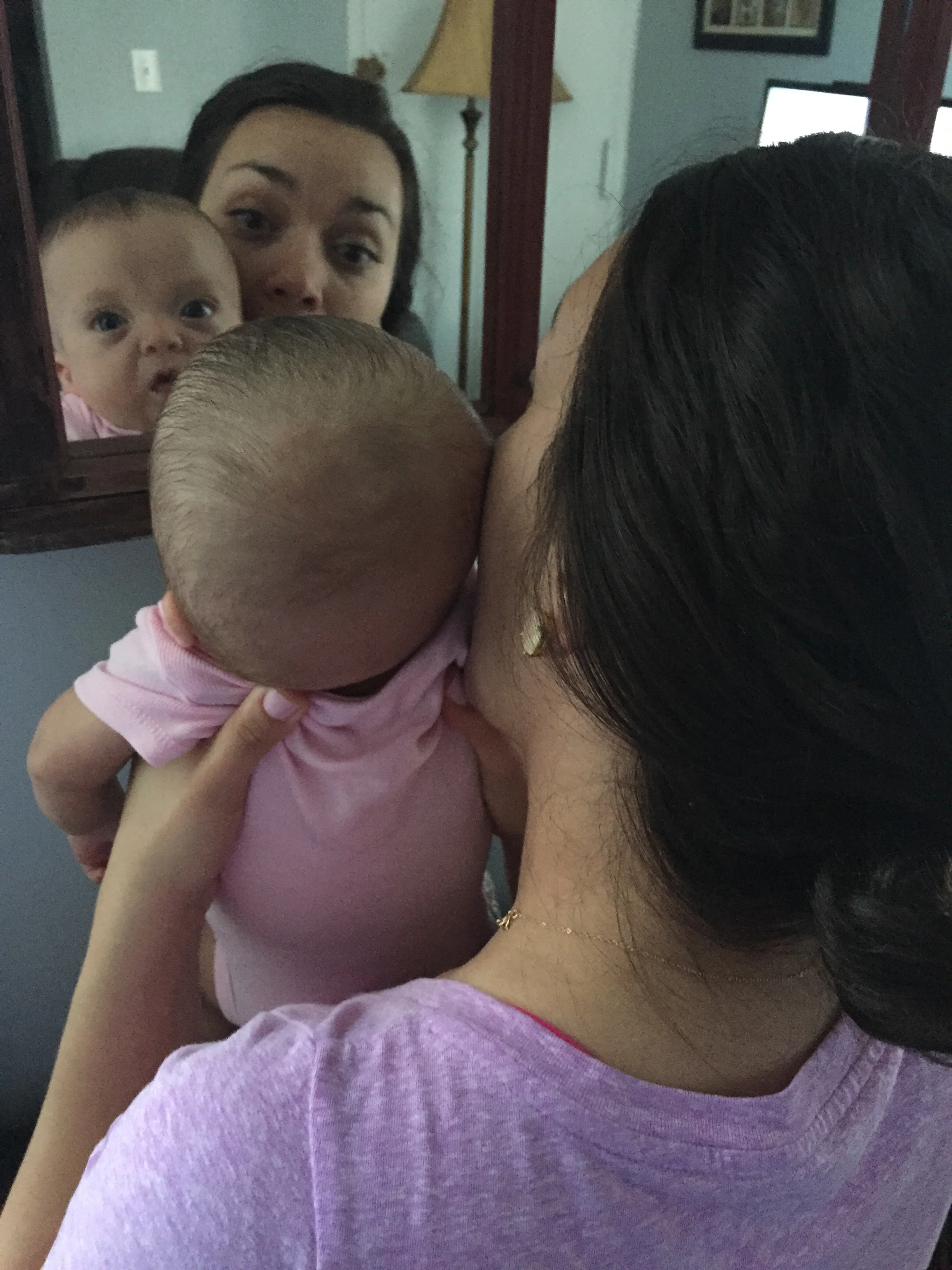 Lucie likes to play and look in the mirror. 