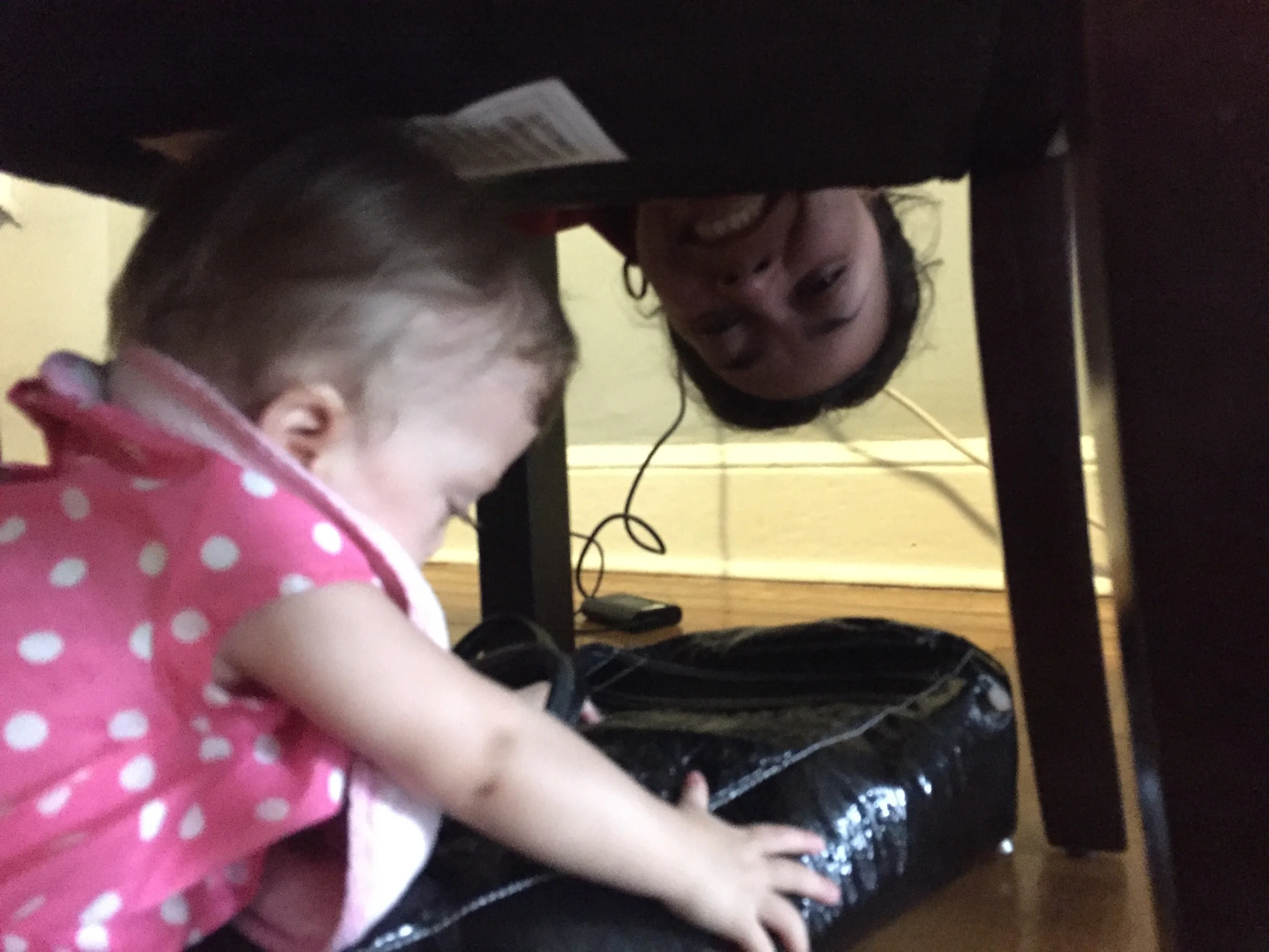 Crawled under the chair to get mommy's purse, almost made it without being caught.