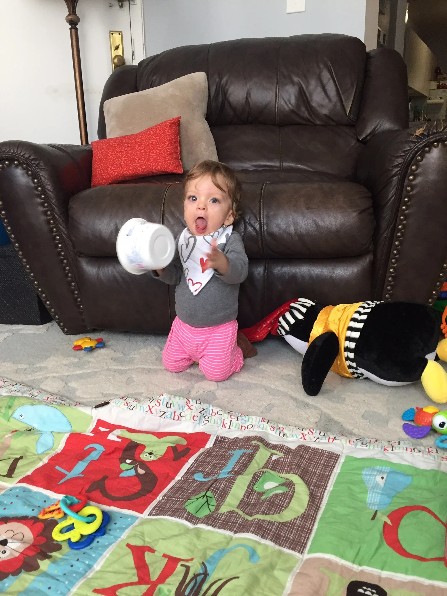 Singing while she "plays" the yogurt bucket. 