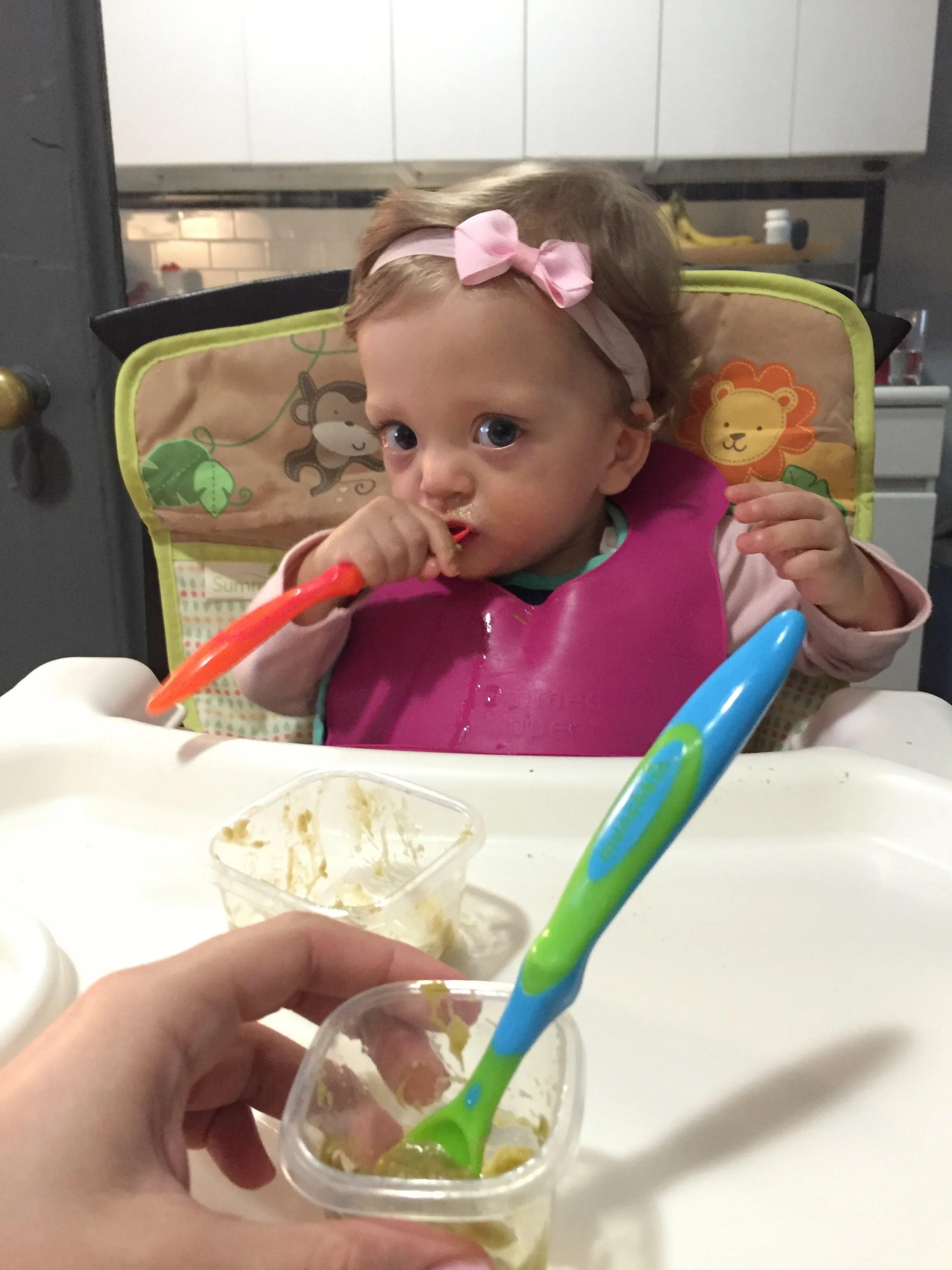 Helping to feed herself