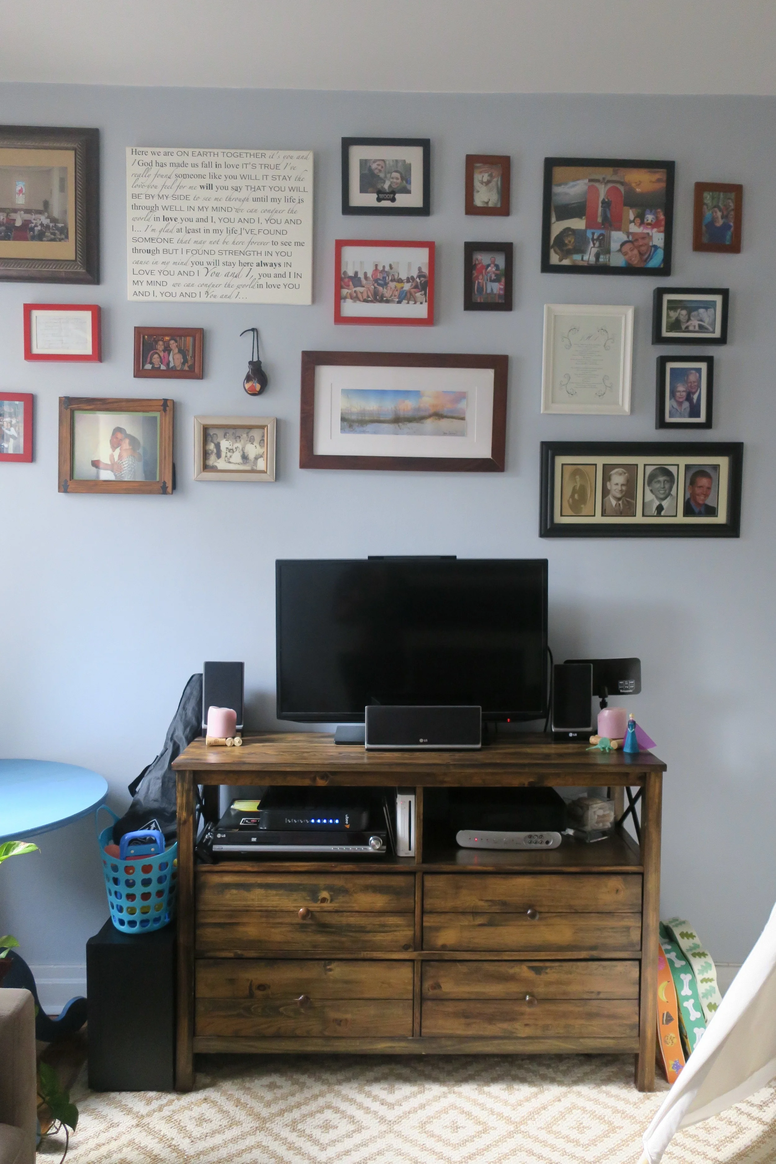  Family Tree gallery wall, and an entertainment center with lots of drawers for Lucie's toys. 