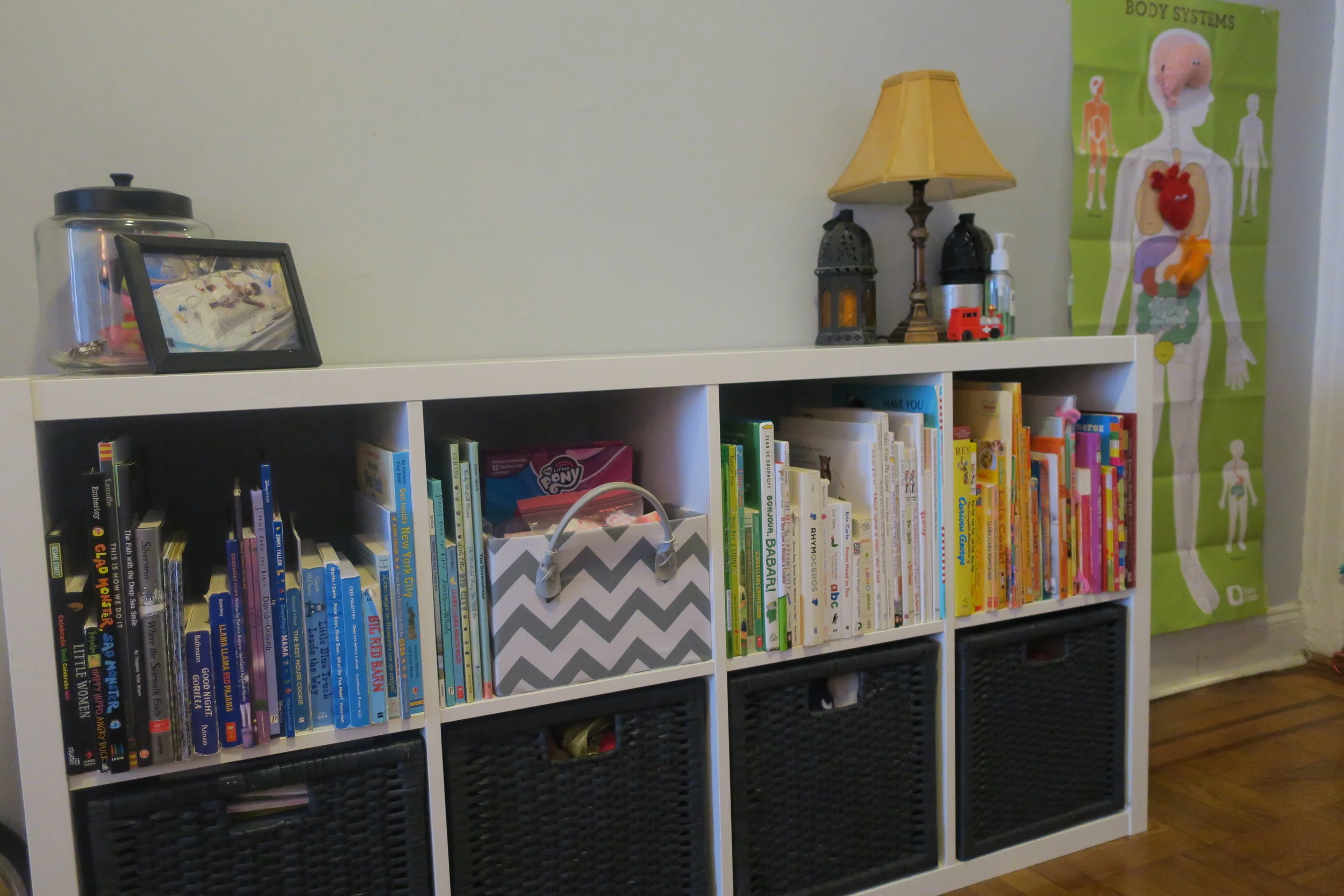  Lucie's shelf with tons and tons of wonderful books. Plus fun bins filled with things for her to play with, color, dress up, stuffed animals, etc. Some of her favorite books right now are,  Everything is Mama, Your Baby's First Word Will Be Dada, Sh