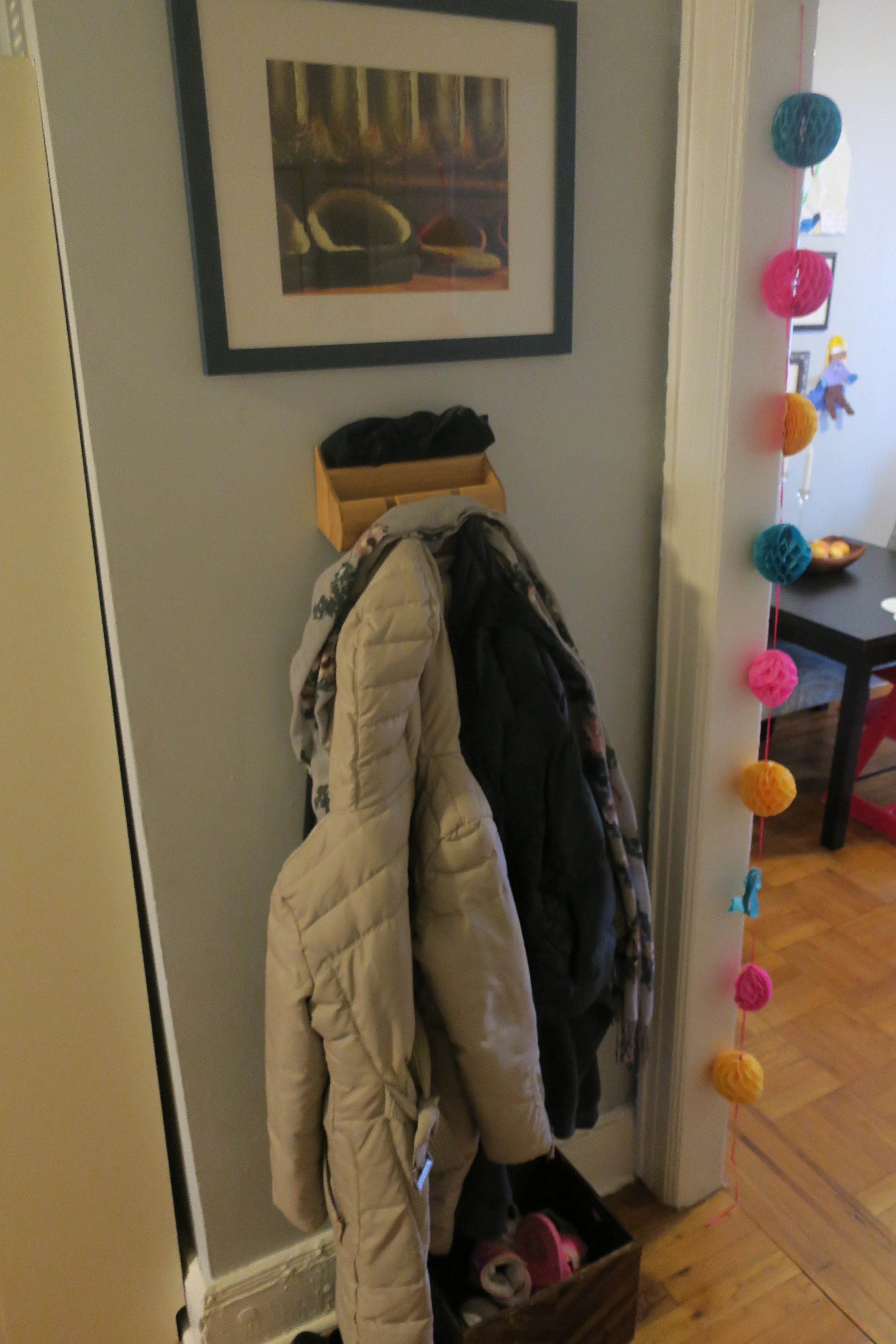  That photograph above the coat rack is one that Robby took in our first apartment in NYC. We would set our slippers under the radiator during the winter months and they'd be so toasty. We titled the photo  Home , and it's such a nice thing to see fi