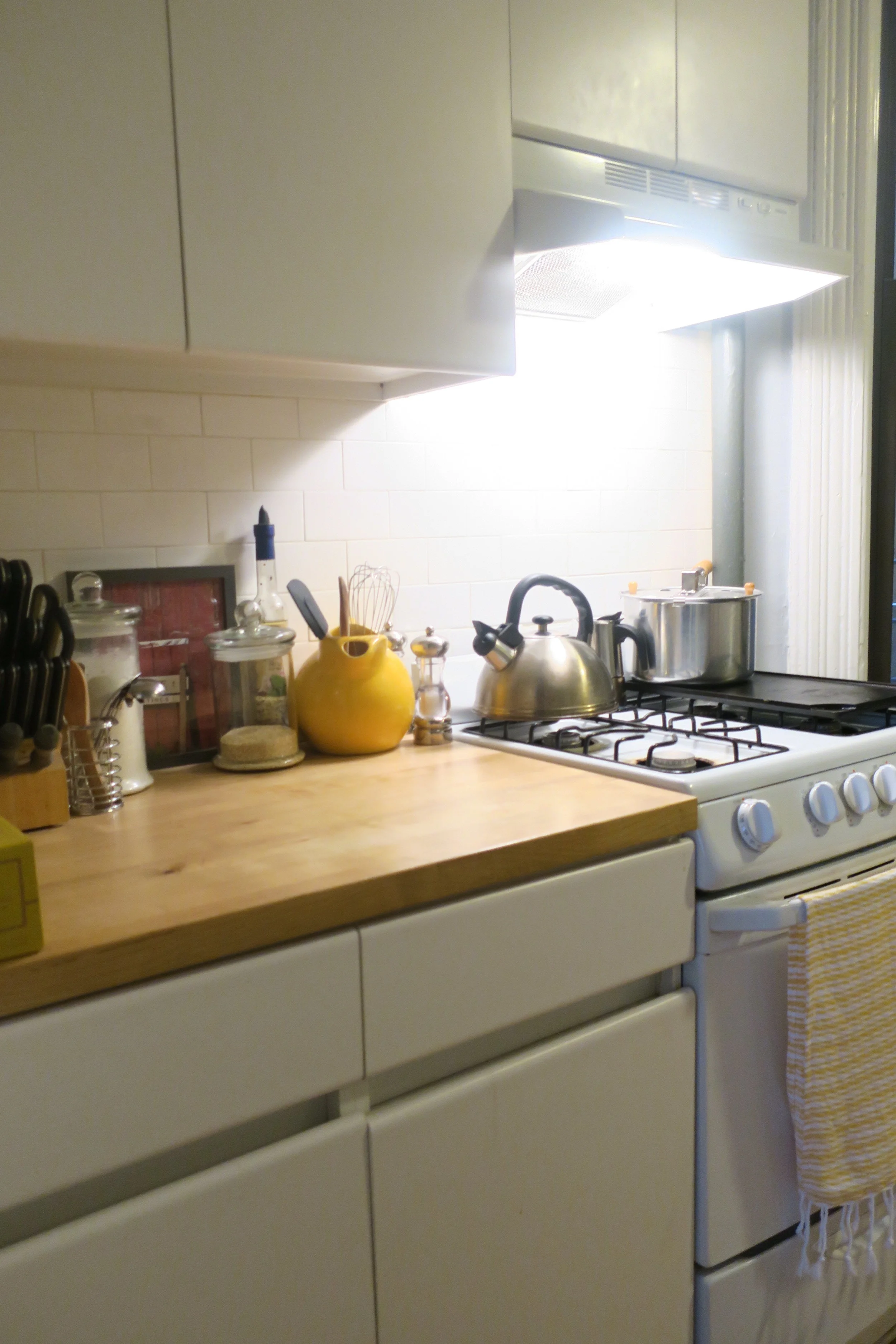  This space may be what sold me on the entire apartment. I love this counter area. So does Lucie. She pulls one of those chairs by the mirror over to the counter, right next to me, so she can stand on it and helps me cook. We got her a set of kid siz