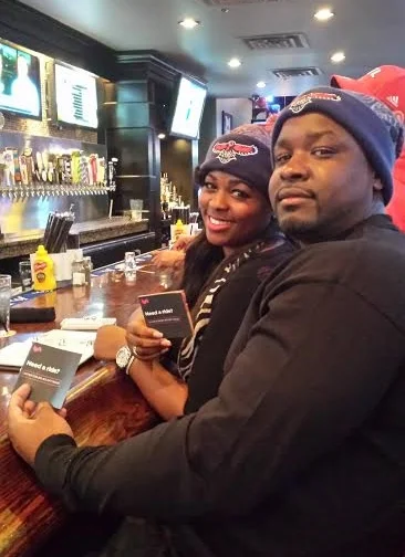 A happy couple shows their love for the Atlanta Hawks and Lyft.