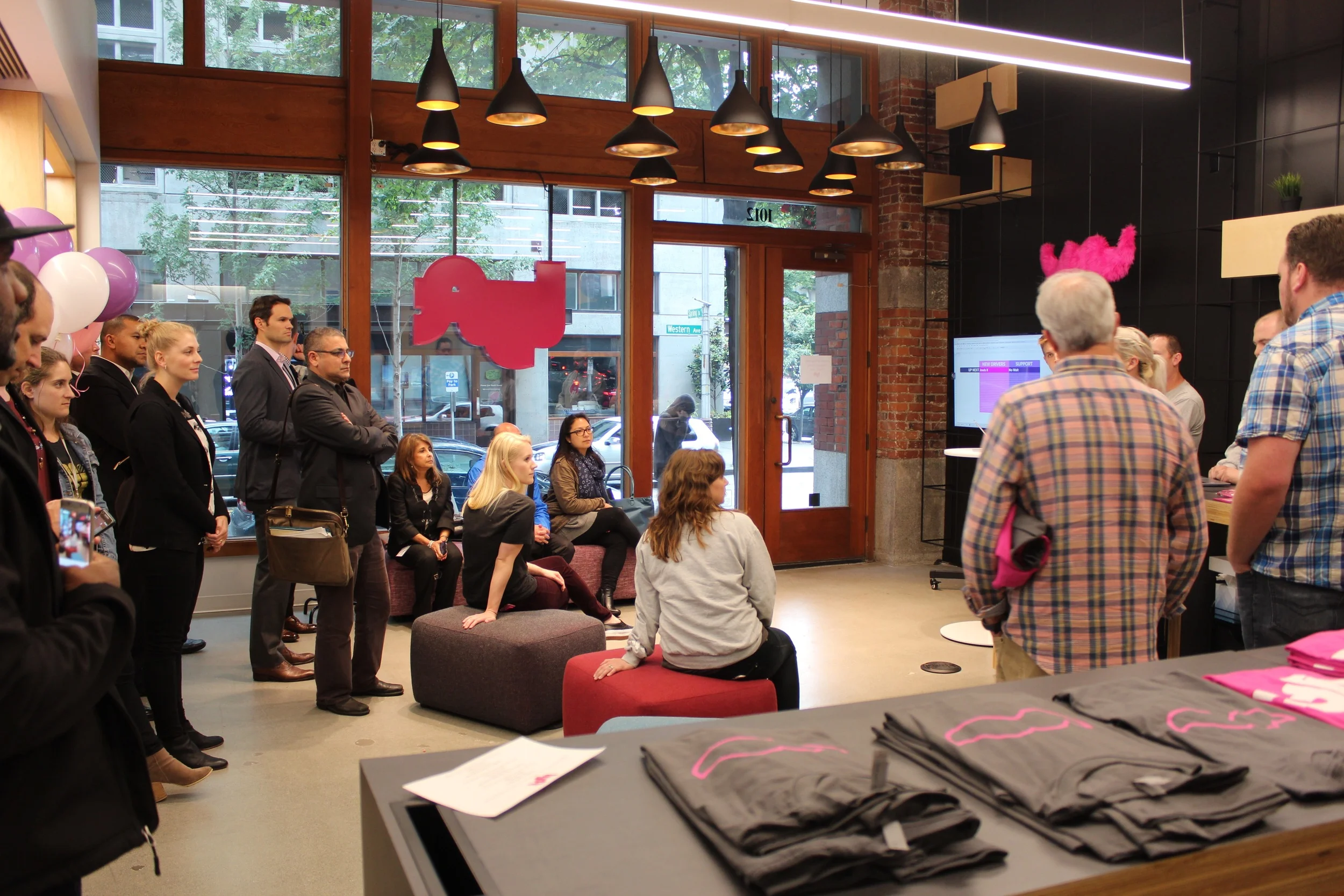 Drivers, local officials, and members of the press filled the Lyft Hub. 