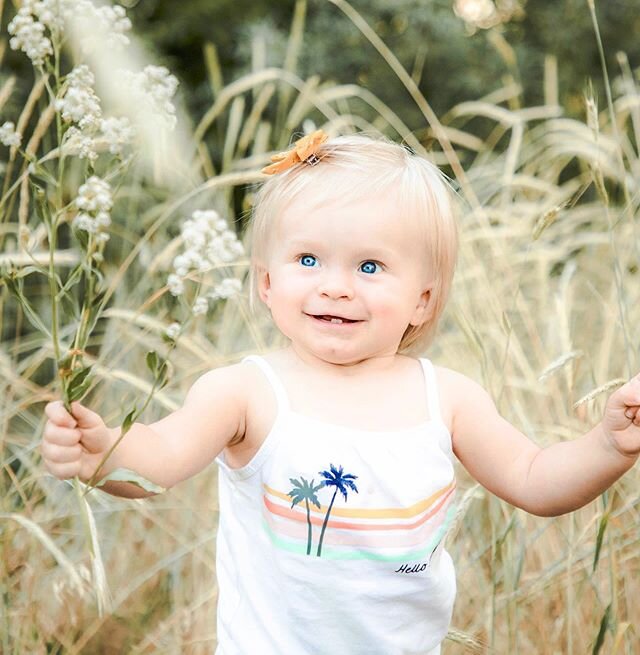 Those 2 little teeth, that chin dimple and those ocean blue eyes. She kills me.