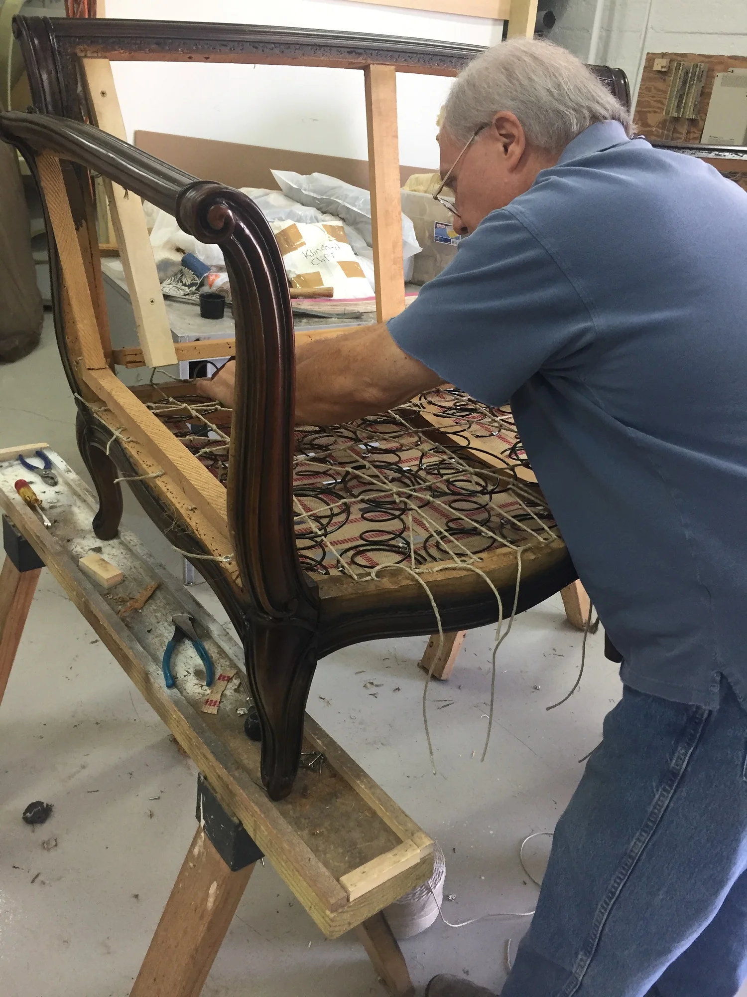 Here’s Bruce in the process of 8-way tying springs.
